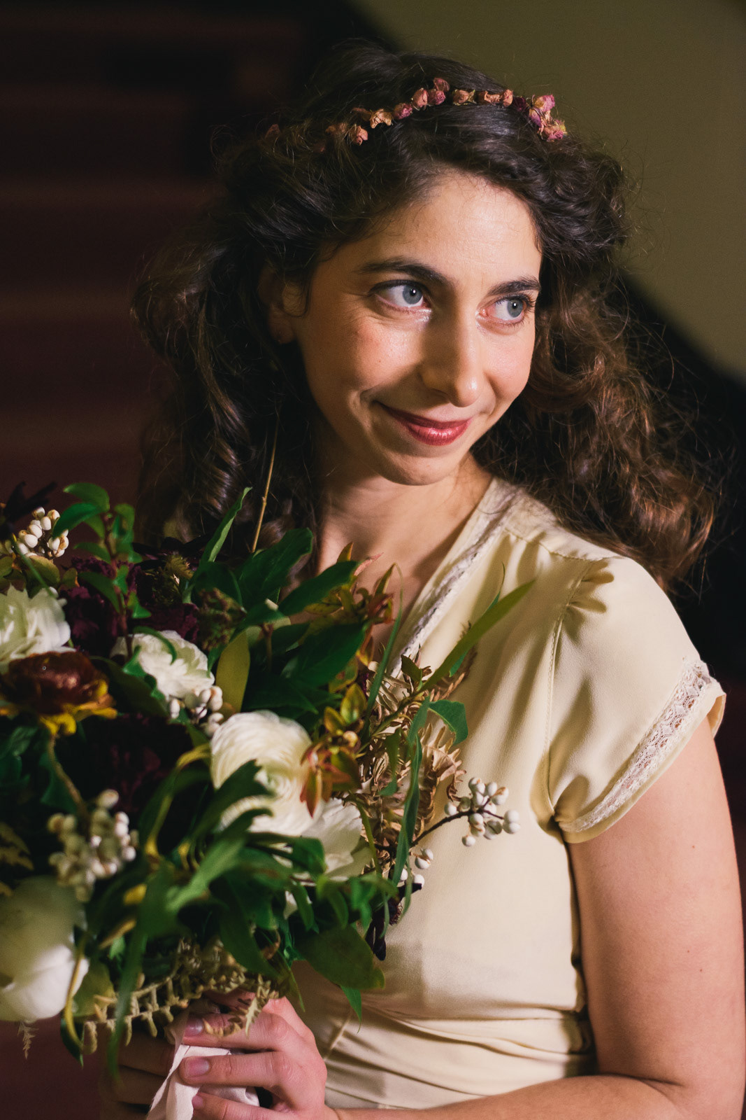 Beautiful bride in handmade dress and flower bouquet