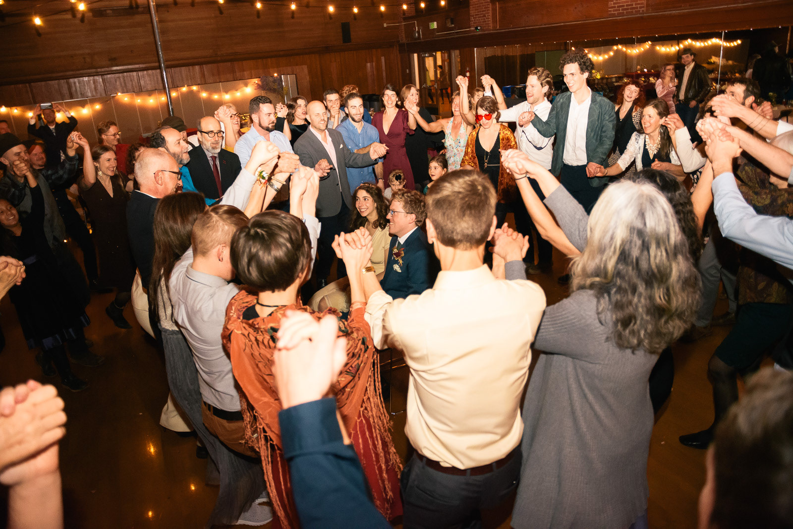 Large group of wedding attendees celebrating the happy couple