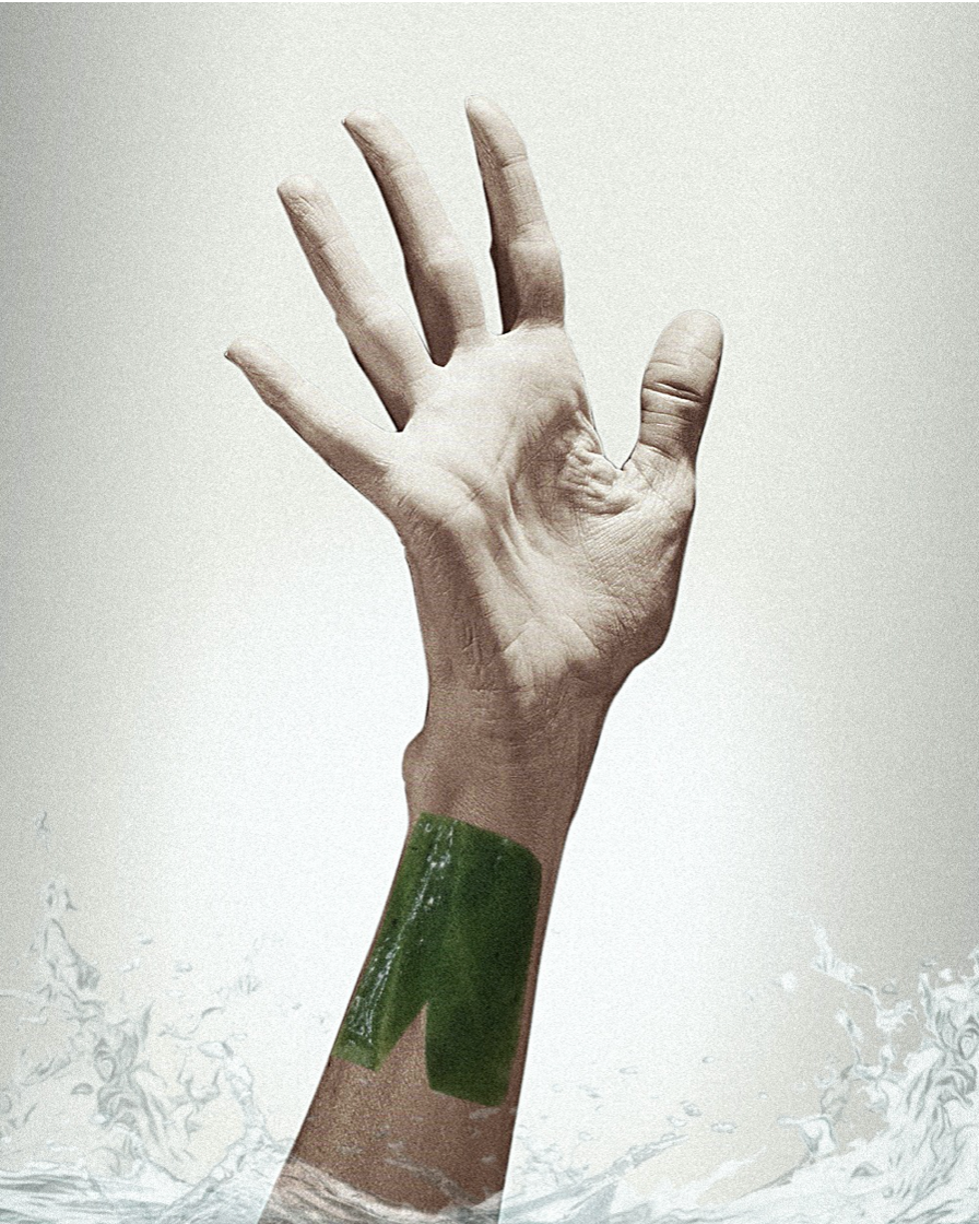 photo of half arm coming out of water. It has an open hand with a green jelly patch on the arm
