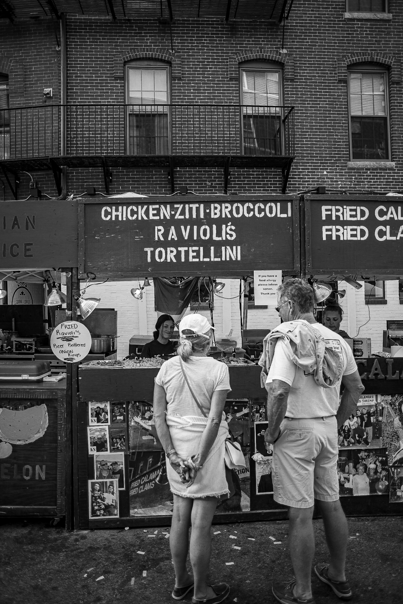 Passerby's visit the Fisherman's Feast in the North End of Boston in August of 2019.  The feast has origins in Sicily and is now organized by descendants of the Sicilian immigrants.