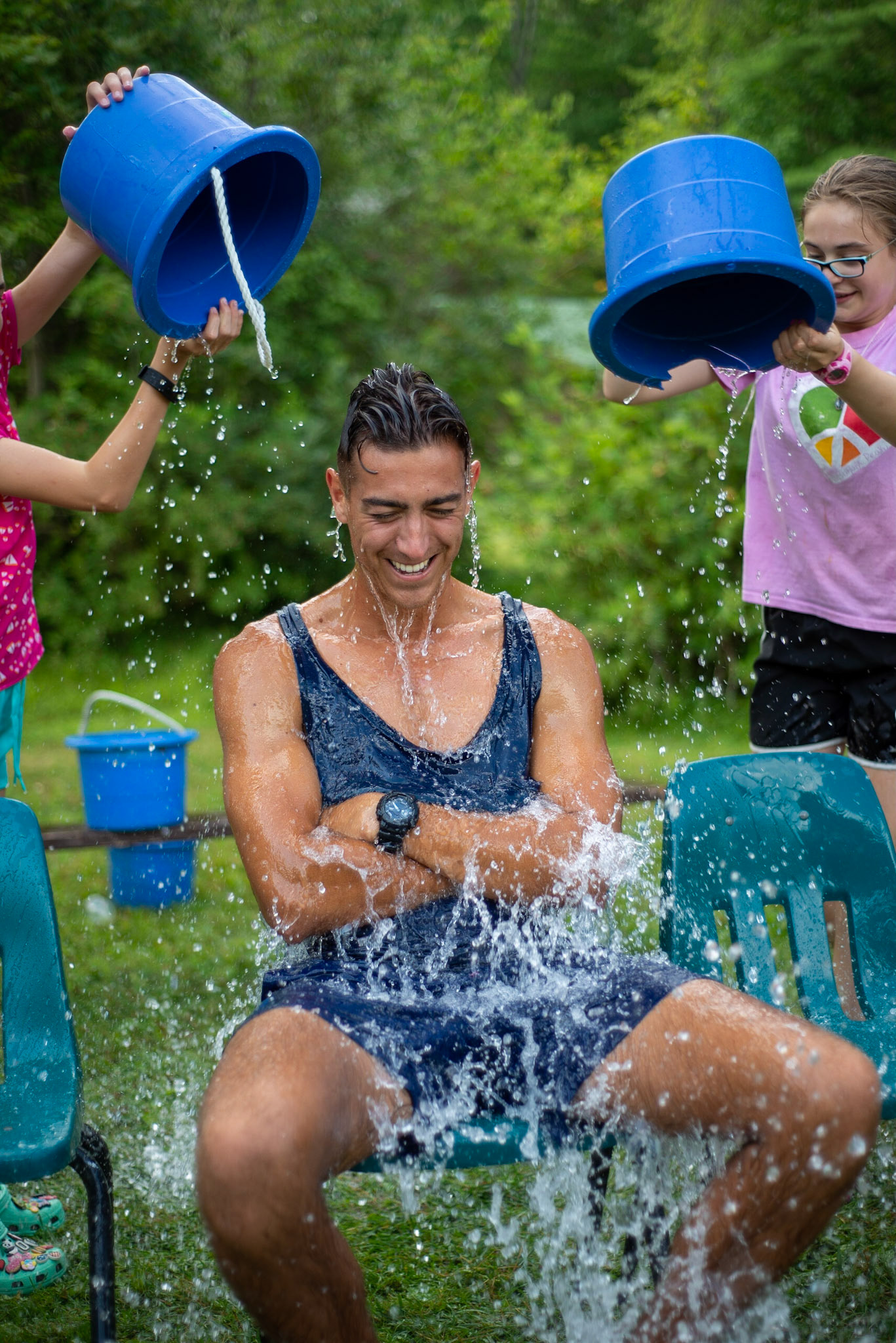 During the last session at Hinsdale-based Camp Emerson, couneslors help campers set up a water carnival.  Matt Blakey has worked as a counselor for two years and makes the trip from the United Kingdom to reconnect with friends and co-workers.  Here he participates in "Pick a Bucket".
