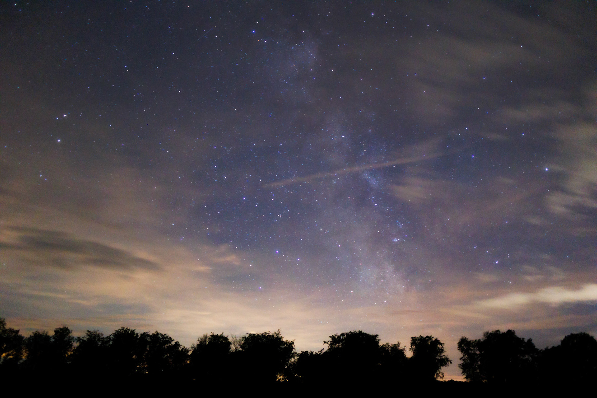 The core of the Milky Way seen behind cloudy skies over Schmalenberg, Rheinland-Pfalz