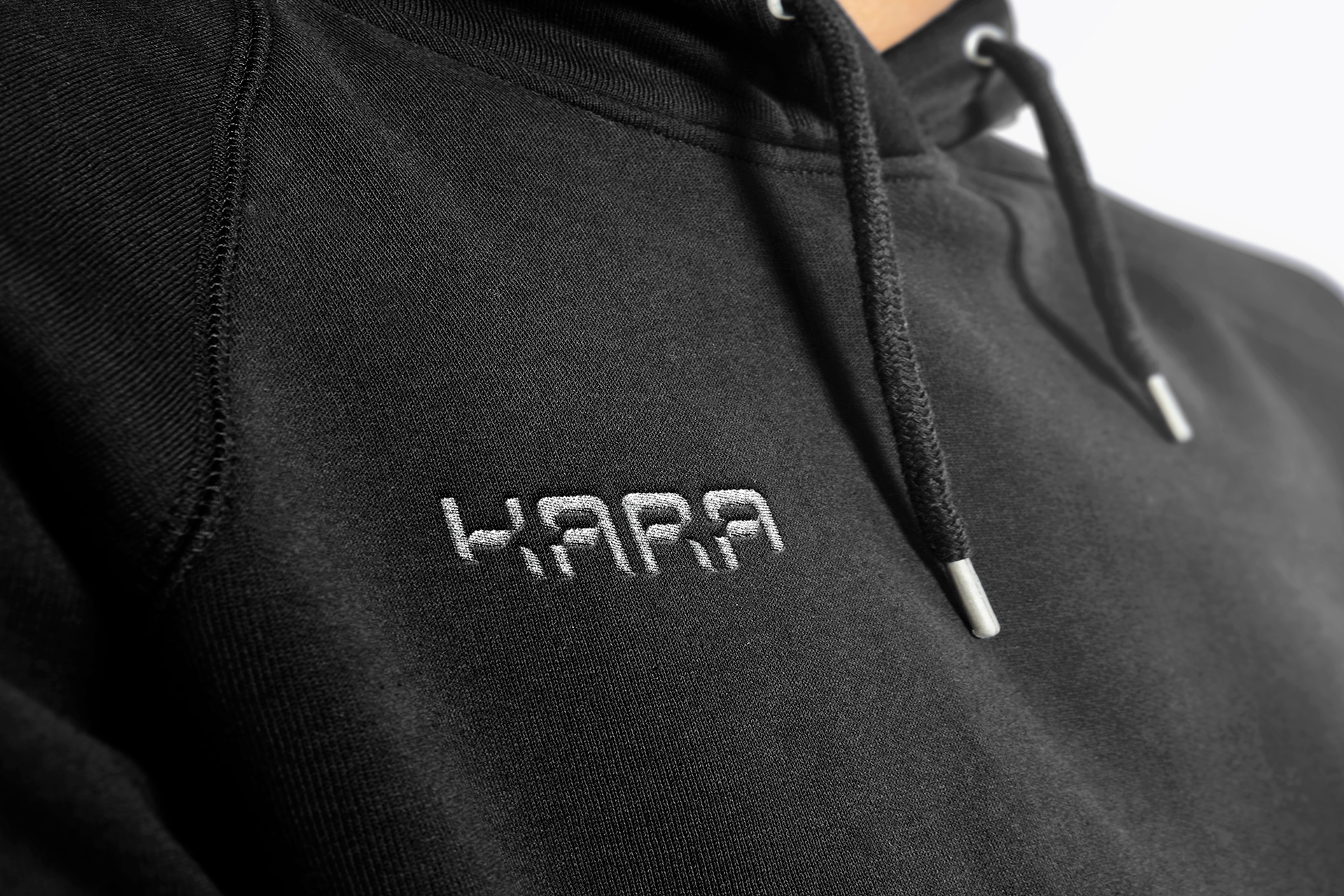 KARA logo embroidered on black hoodie design by Karan Sandhu.