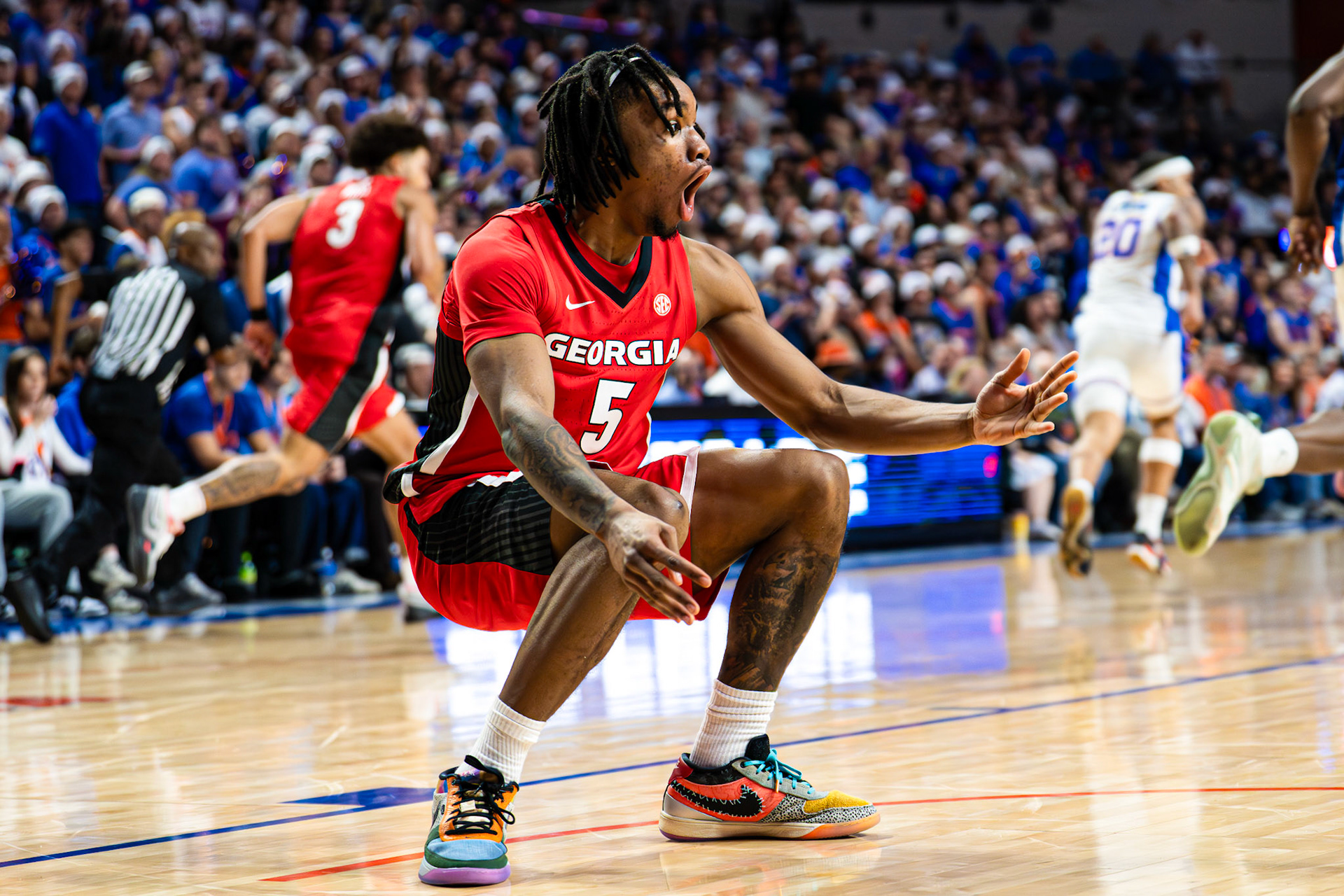 Georgia guard Jeremiah Wilkinson (5) in shock after ref’s lack of foul call on Florida during the second half of an NCAA college basketball game  Tuesday, Jan. 6, 2026, in Gainesville, Fla. (AP Photo/Morgan Hurd)