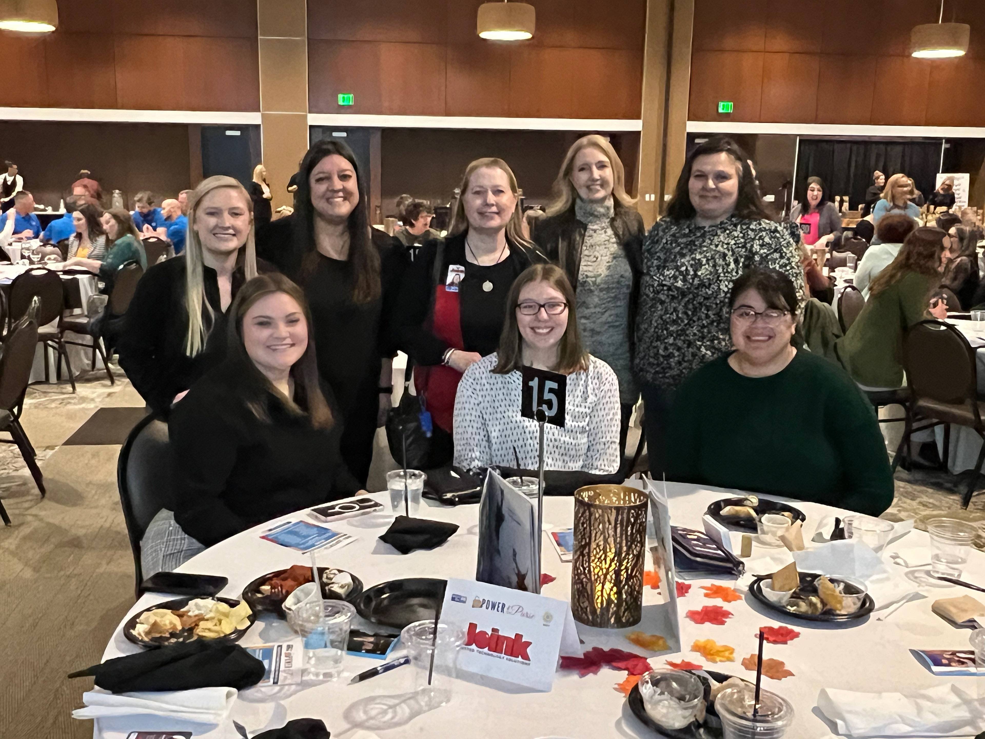 United Way's Power of the Purse event, October 27, 2022, at the Terre Haute Convention Center. Madison Marshall, standing at left, is the Scott College of Business Mentoring Coordinator.