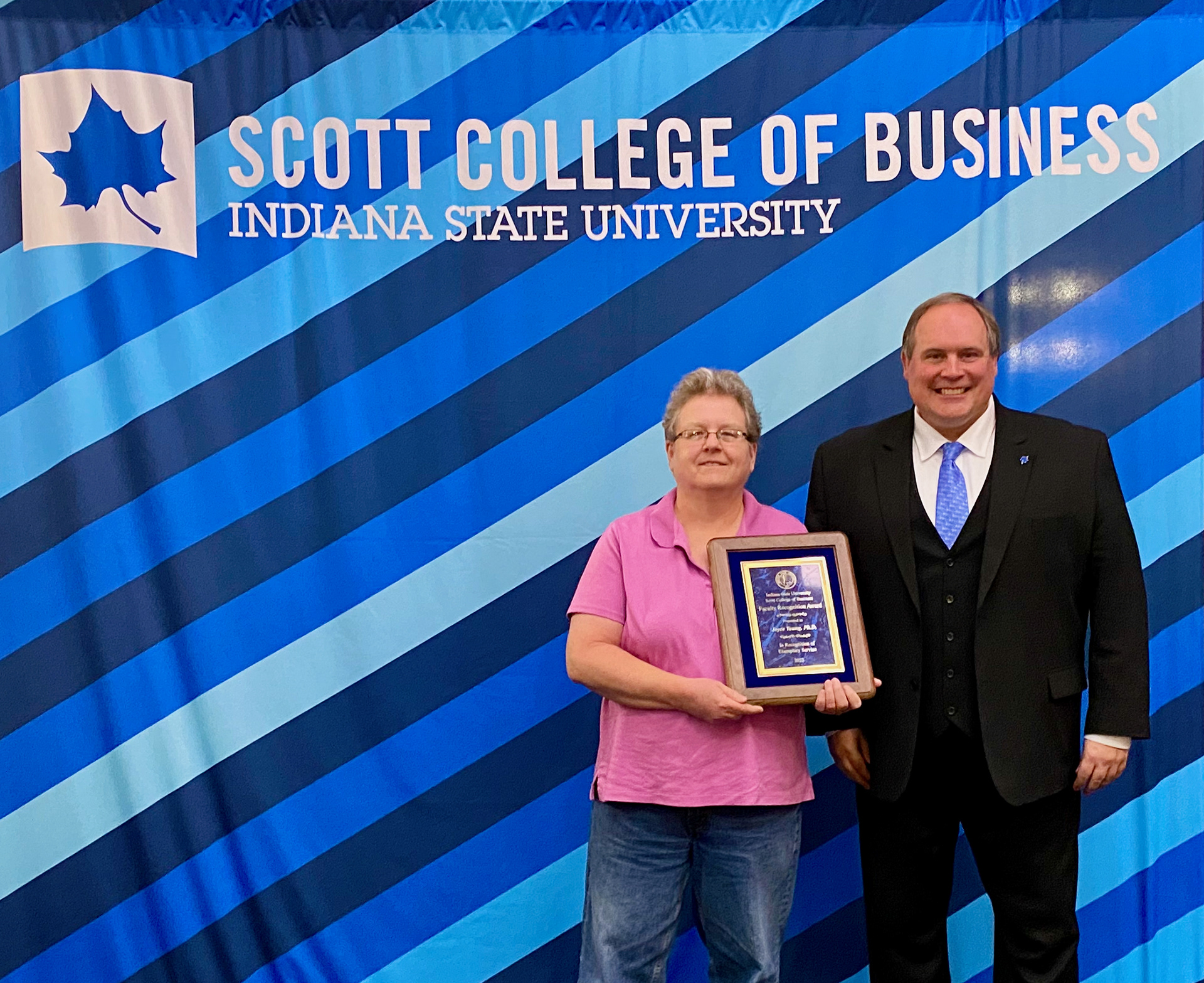 Joyce Young, Professor of Marketing, receiving her College Service Award from dean Terry Daugherty. April 22, 2022