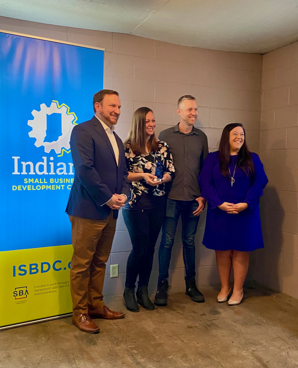 State Director of the Indiana Small Business Development Center, David Watkins, and Courtney Richey, presenting the award to 3 Sisters Investments
