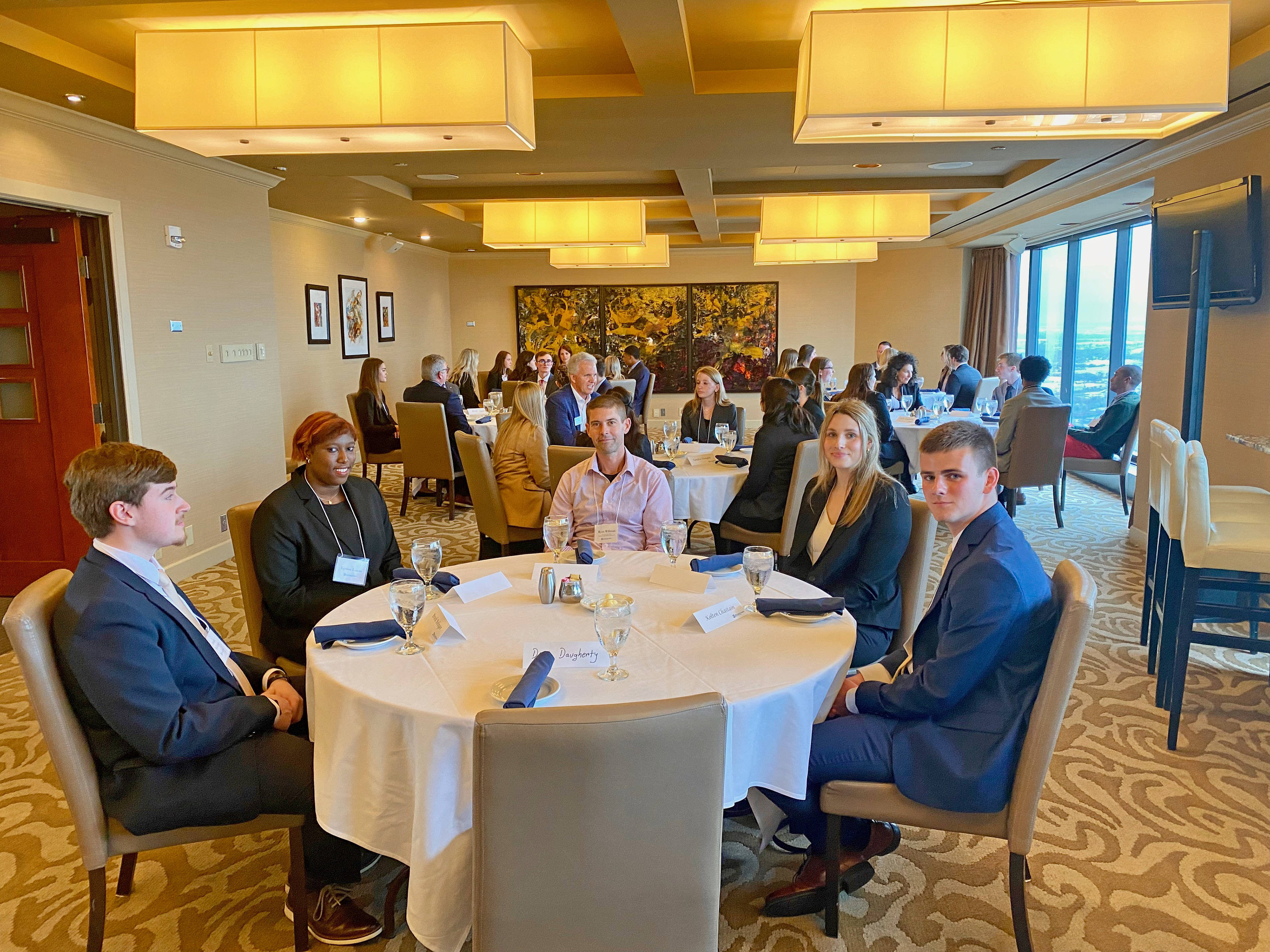 The Executive Dining Experience held on April 13, 2022 at the Skyline Club in Indianapolis. Pictured at front are students Lynise Lucas, Brock Bolinger, Andrea Putrimas, and Kolten Chastain with Ryan Willman, Chief Accounting Officer at Calumet Specialty Product Partners, L.P.
