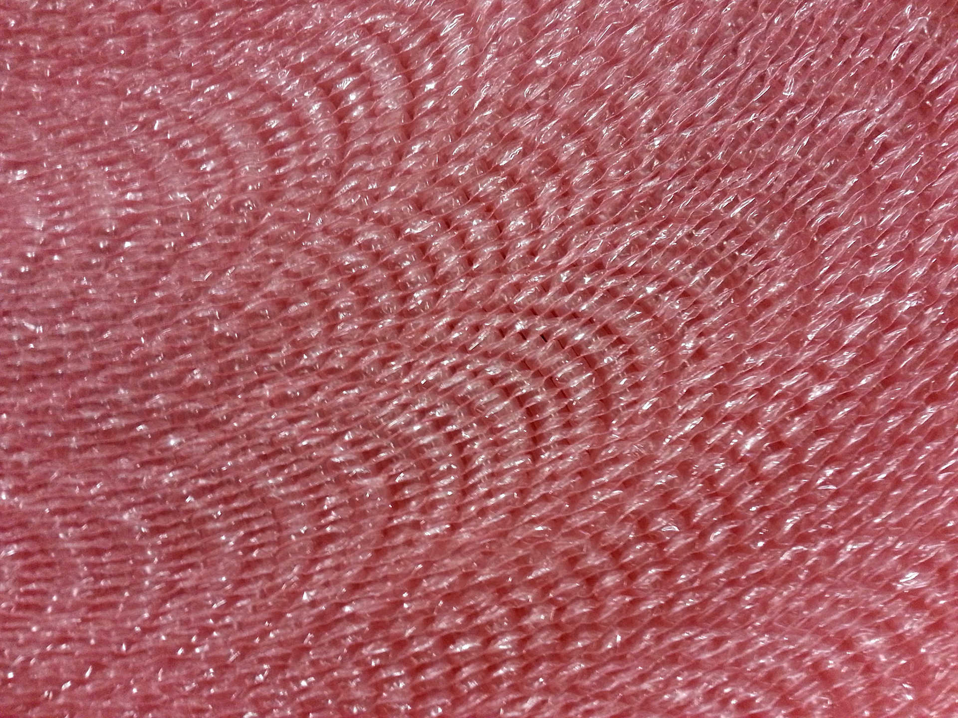 Patterns repeat in a large roll of antistatic bubble wrap.