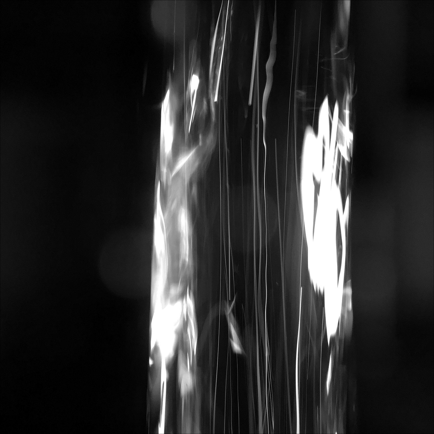 Light from a small LED flashlight passing through a stream of water.