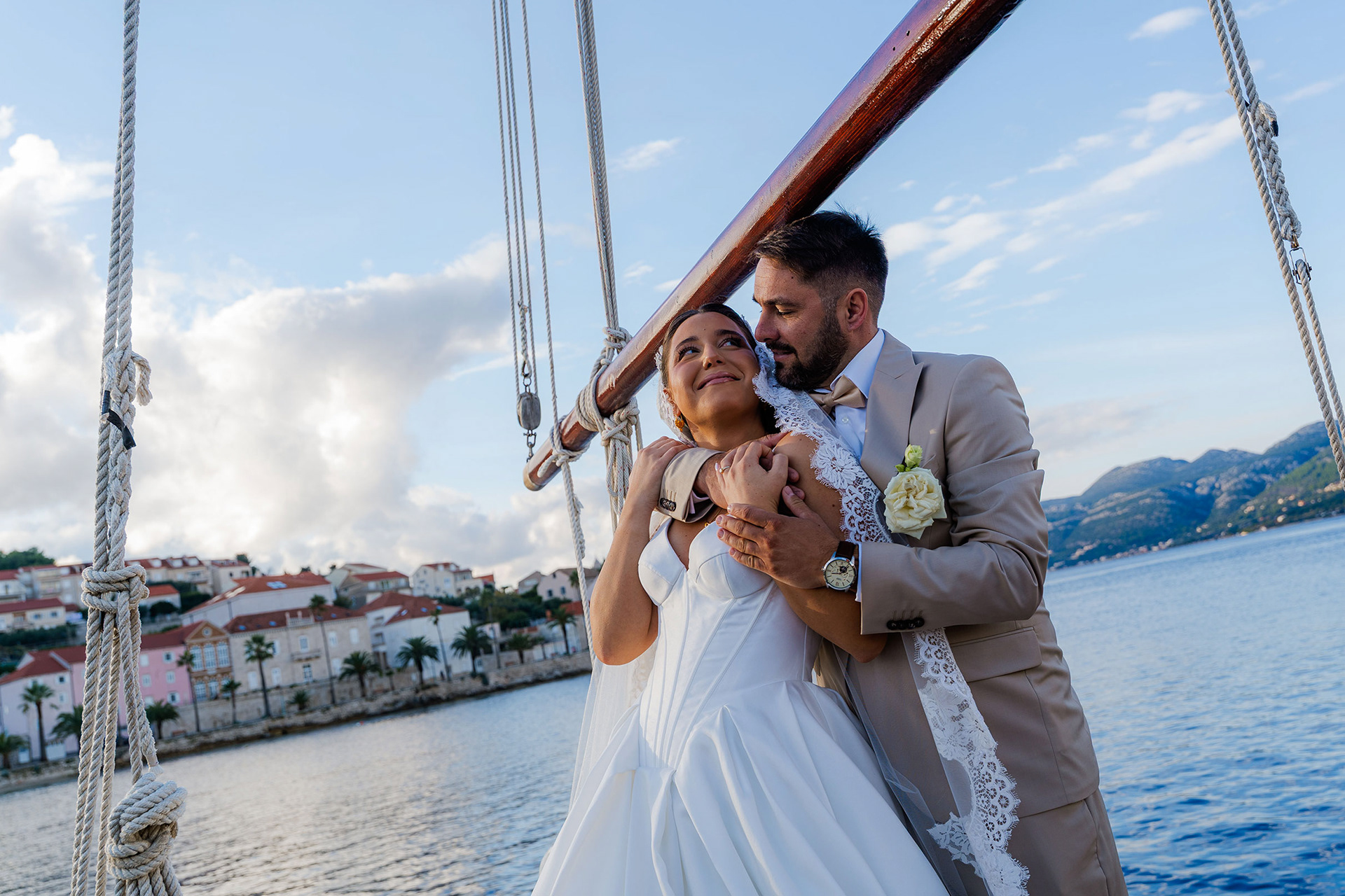 Intimate wedding portrait on boat in crystal clear Adriatic waters