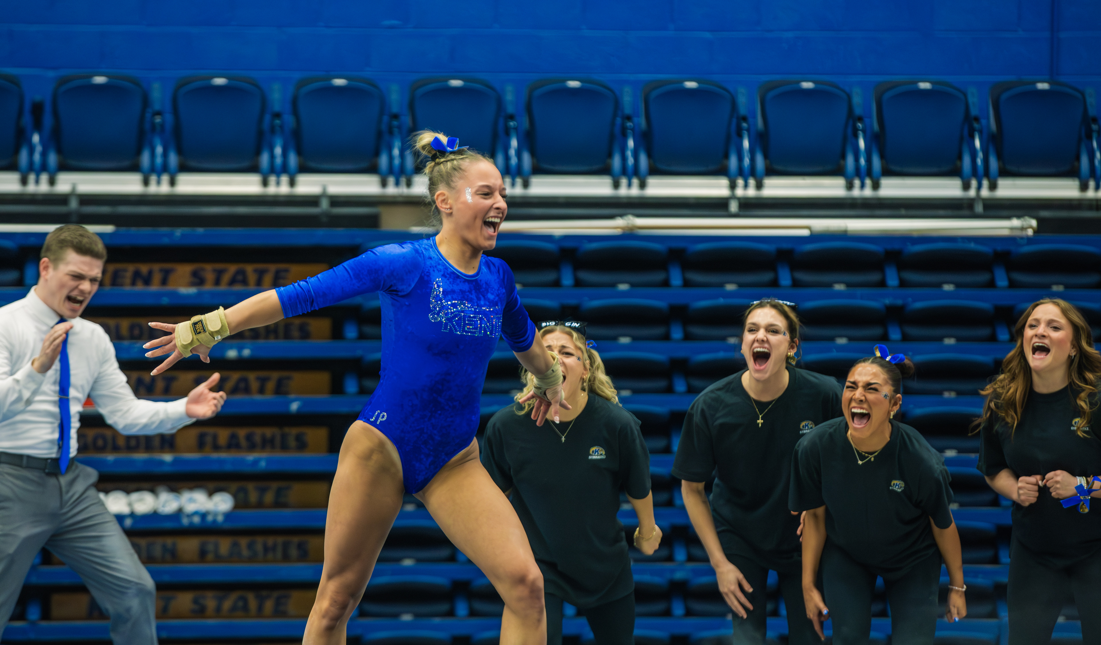 The landing is perfect and the entire Kent State bench knows it as a Flashes gymnast spreads her arms wide as coaches and teammates erupt behind her.
