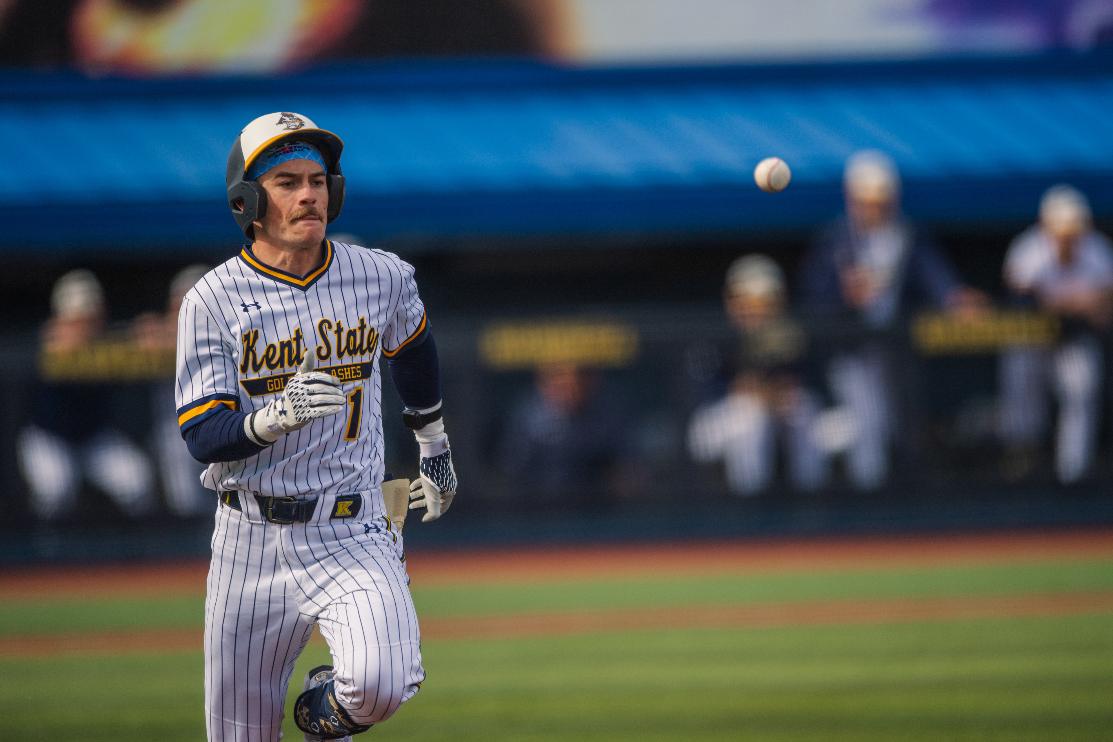 Kent State's #1 runs the bases with the ball drifting in the upper corner of the frame. A frozen moment between the crack of the bat and whatever comes next.