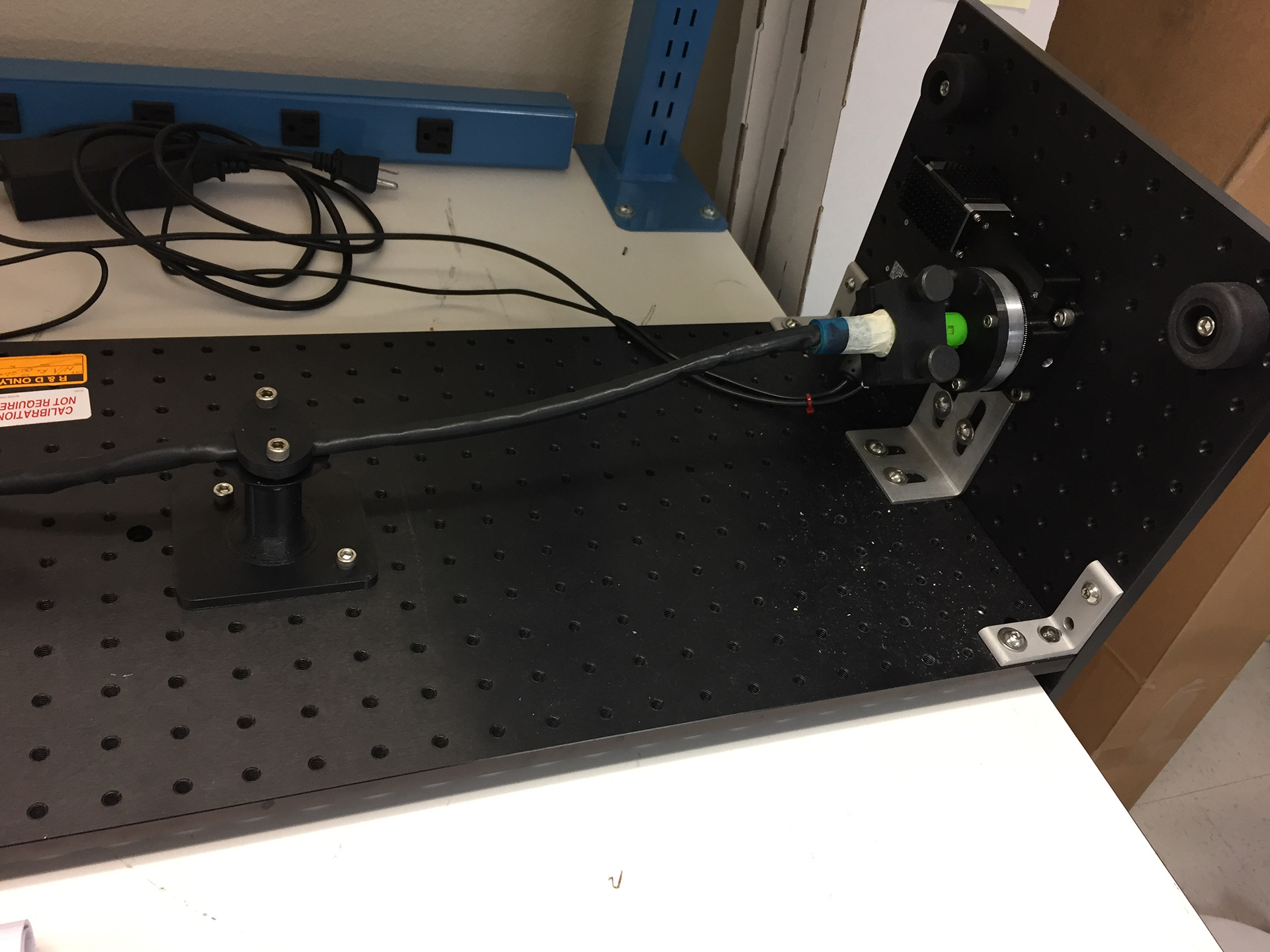 Test set up used to conduct reliability testing of a cable. A rotary stage and python script was used to control the twist of the cable.