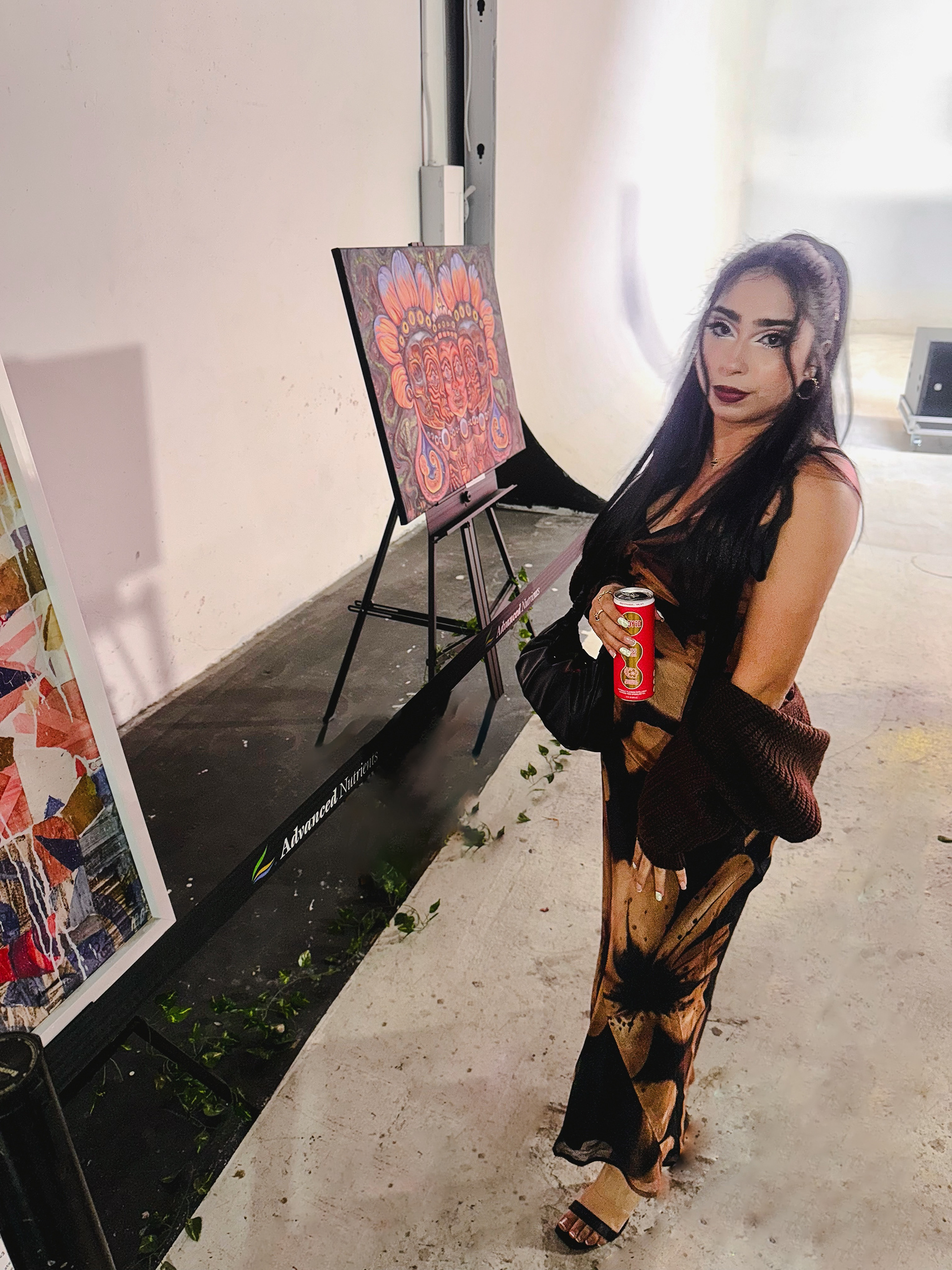 A picture of myself with my Art in display at Grammy's Lomg Beach Event