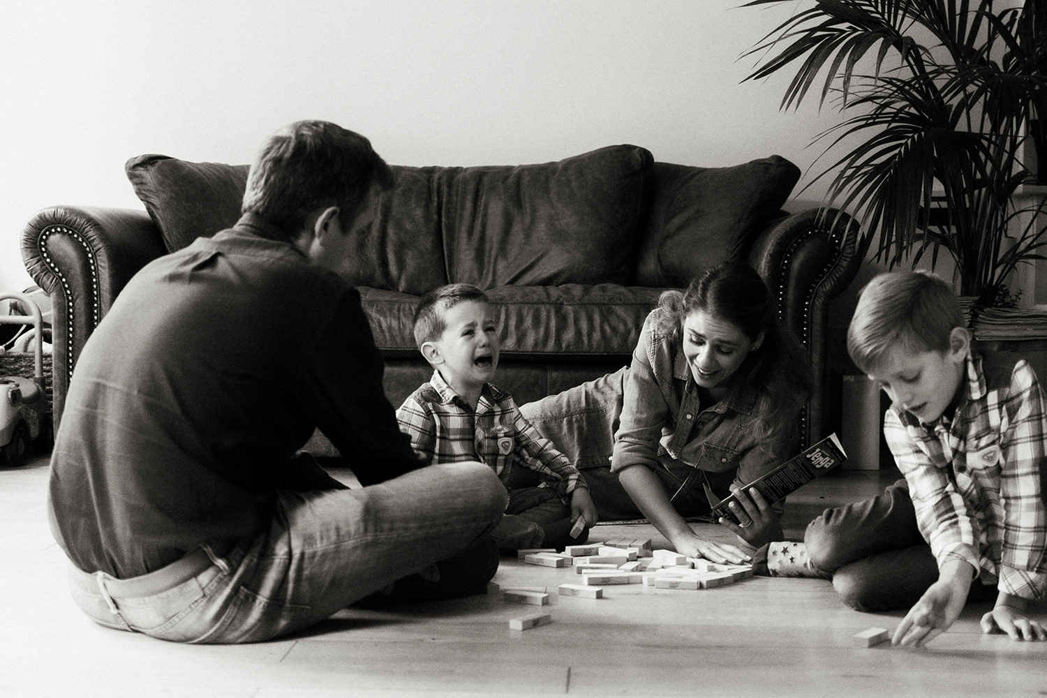 little boy crying after losing jenga