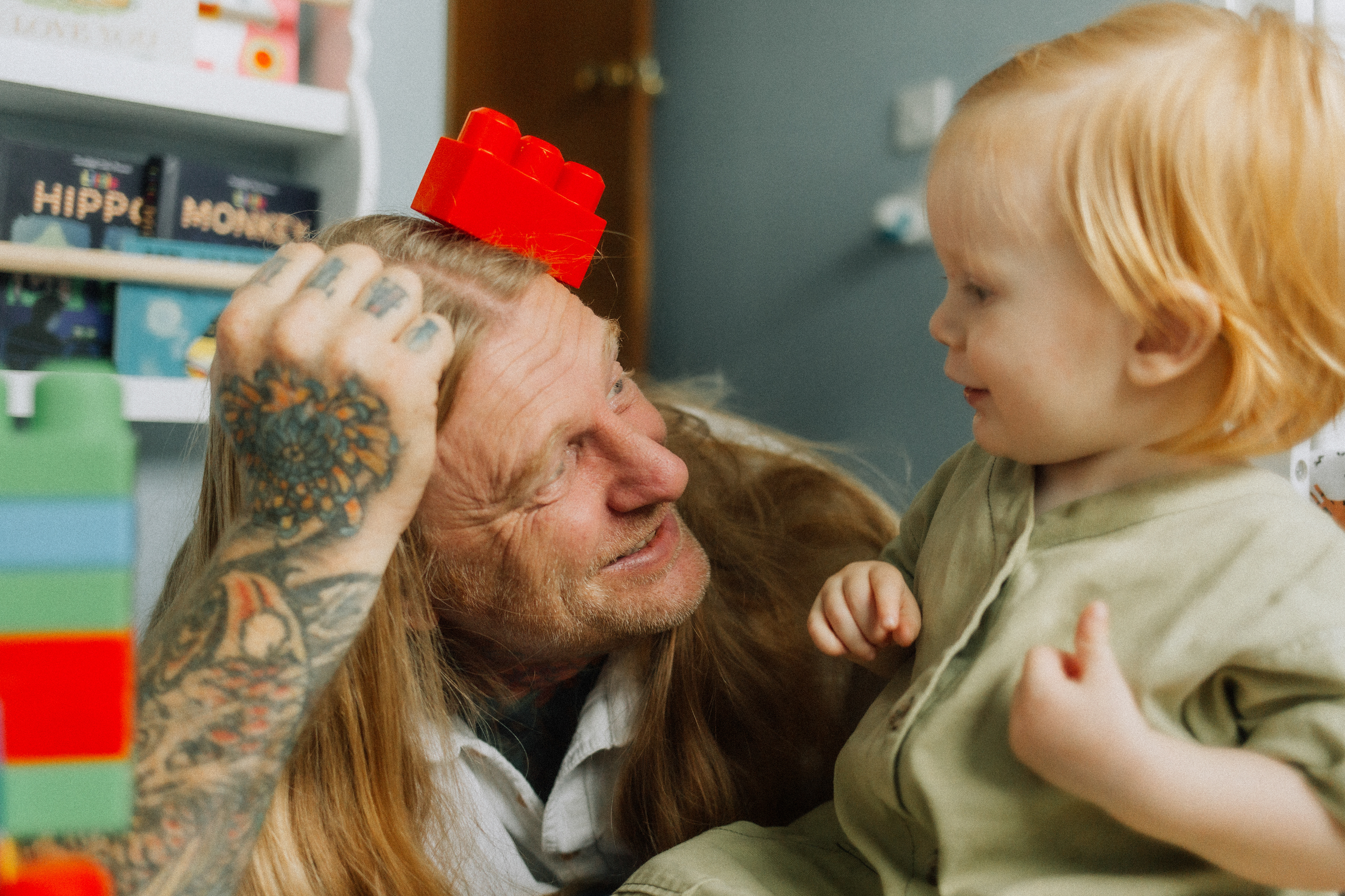 dad balancing a red building block on his head