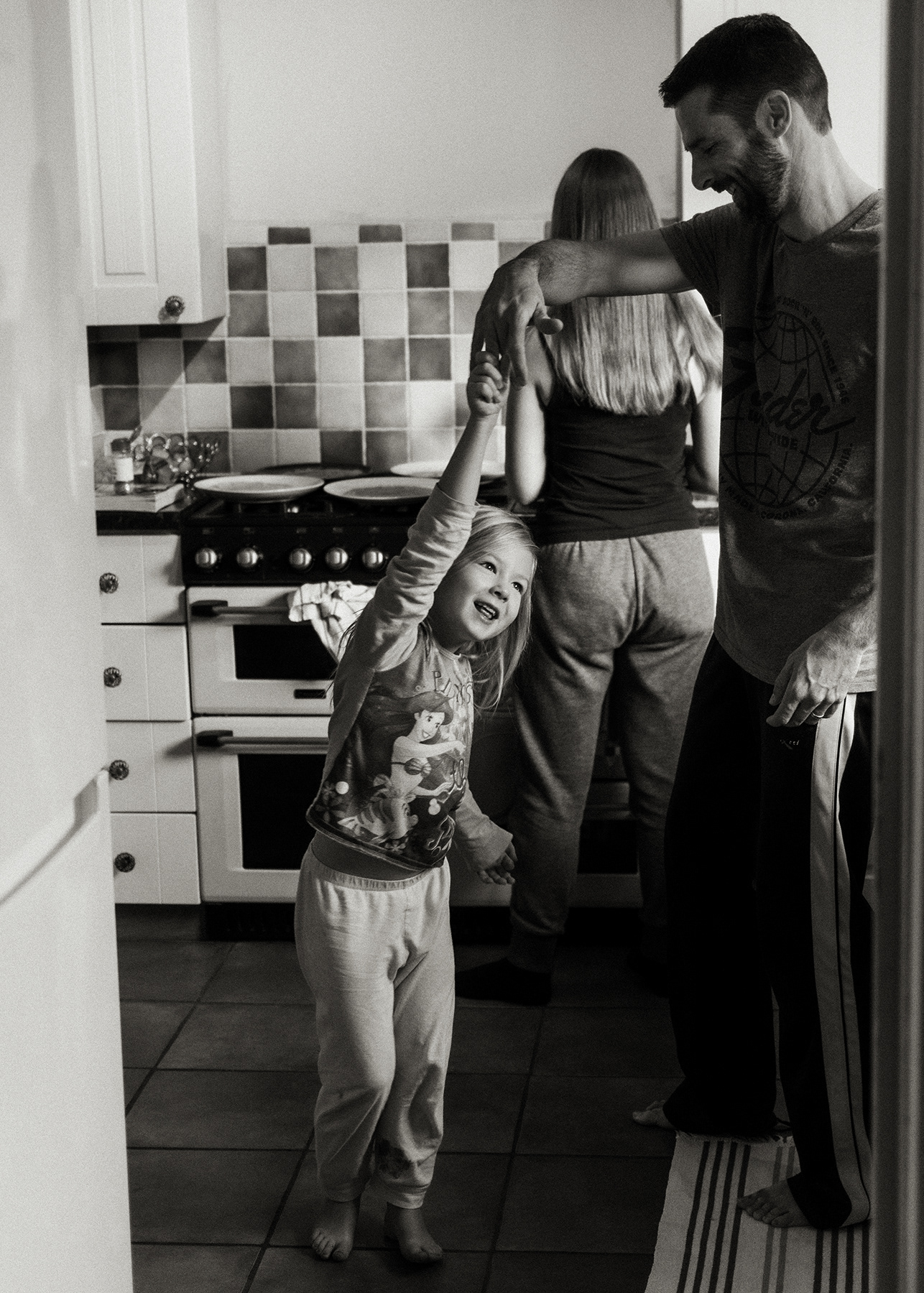 father and daughter dancing in the kitchen
