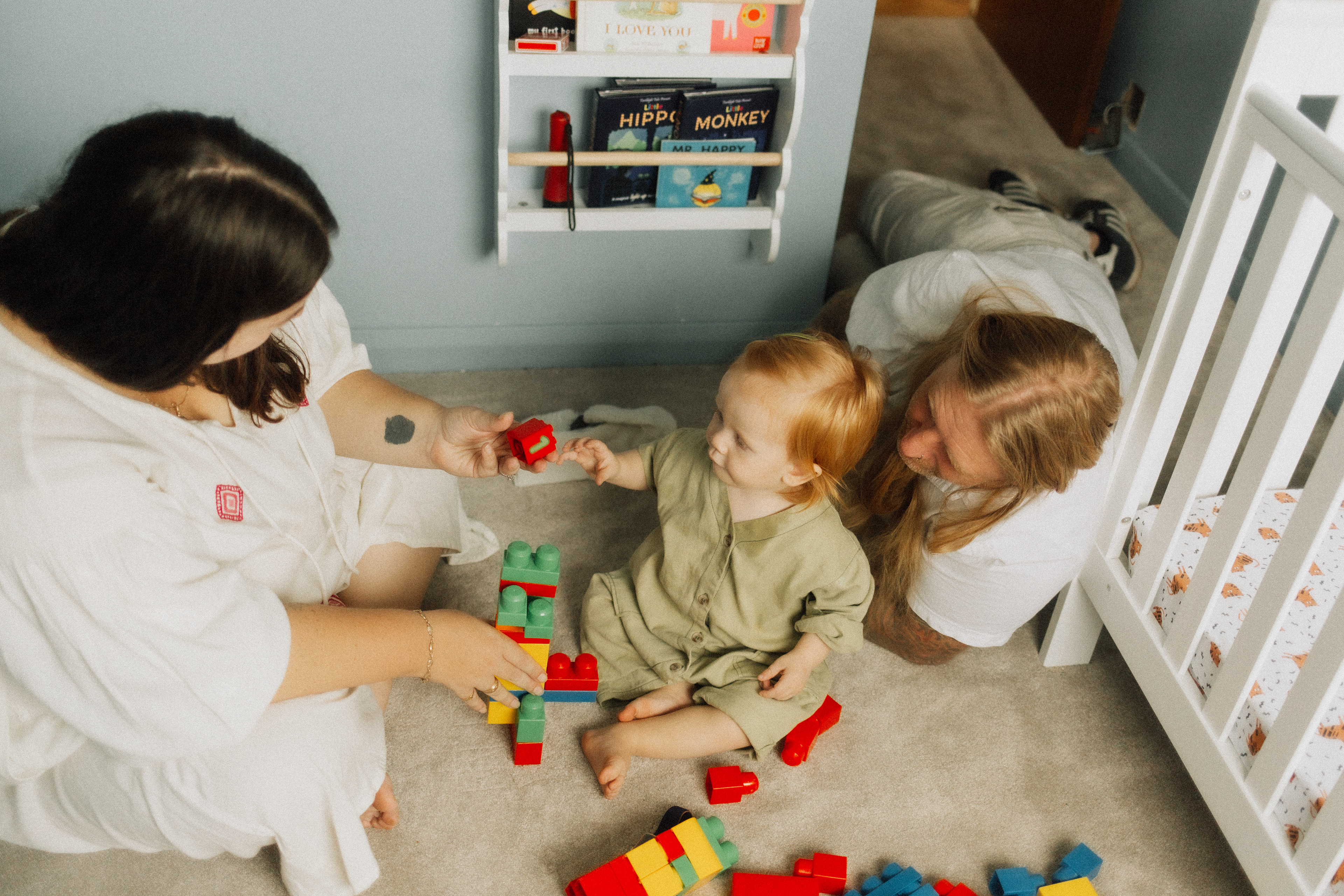 family playing in room with building blocks