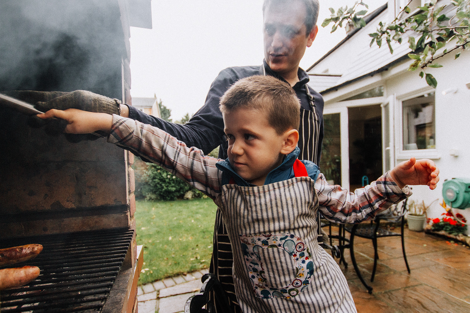father and son barbecuing together