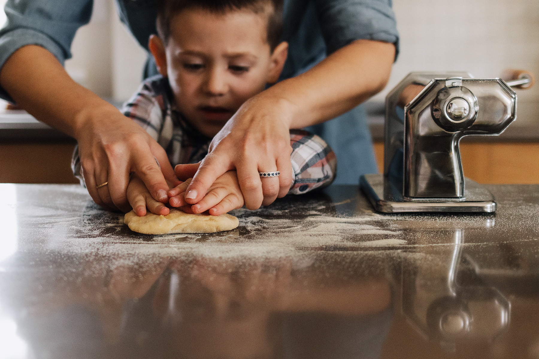mother and son kneading dough