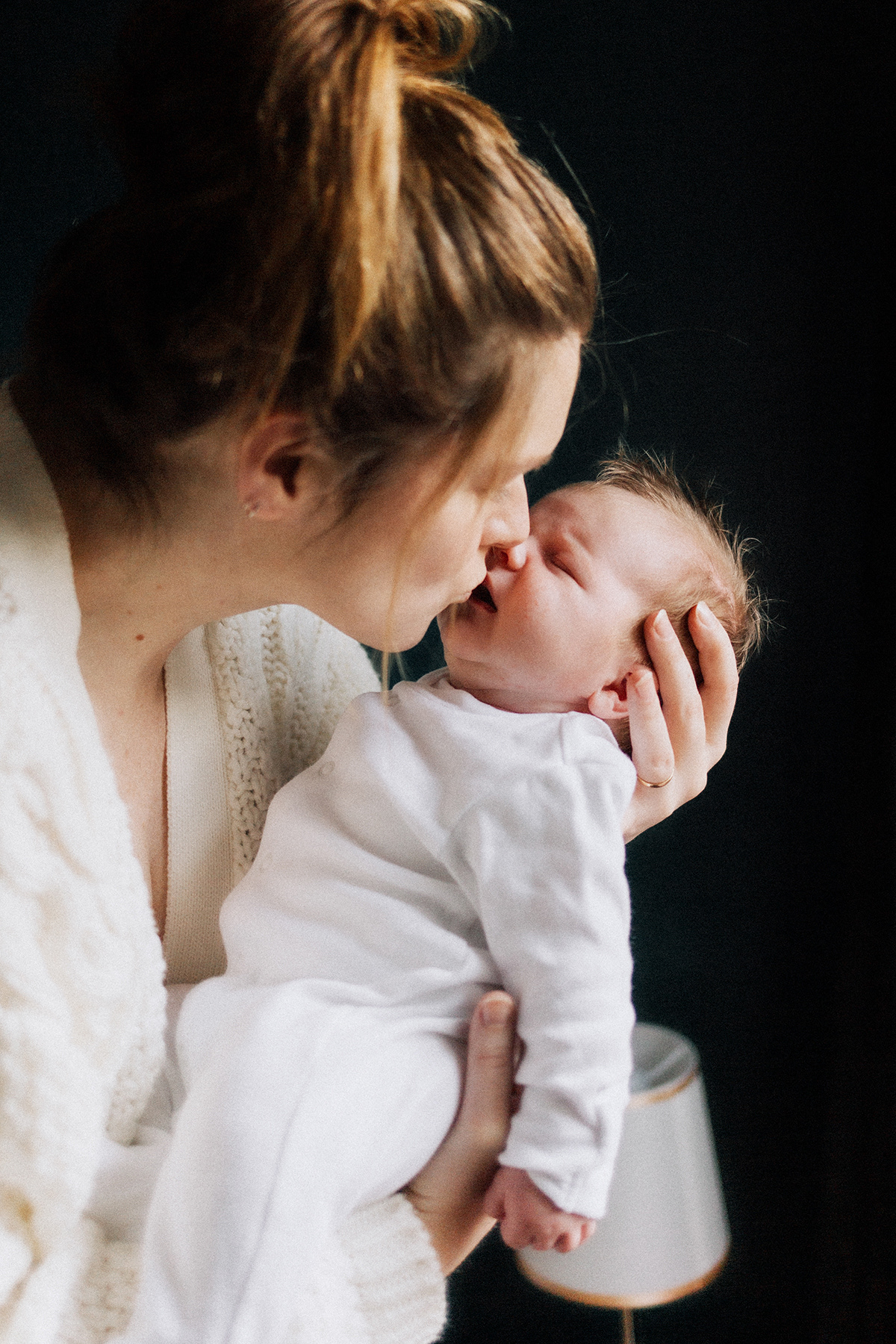 mother giving baby a kiss