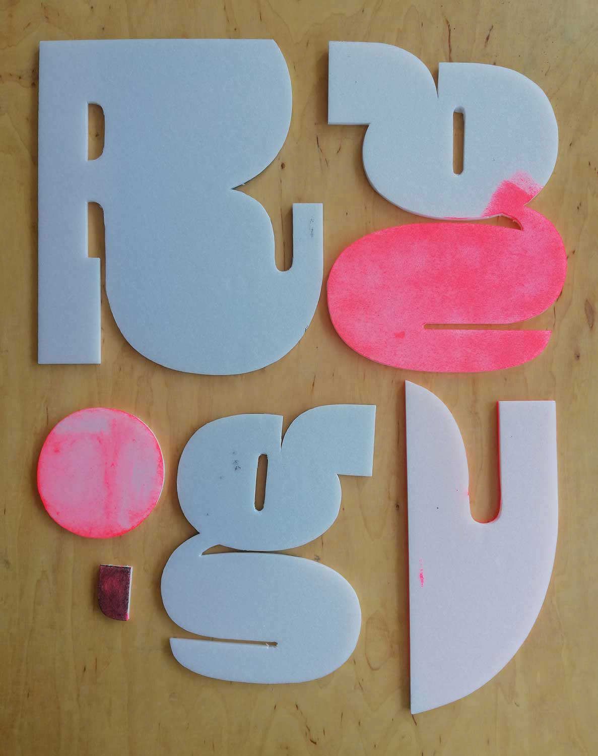 Prozessbilder: Typografische Experimente mit handgeschnittenen Buchstaben. Abstraktion der Buchstaben. 