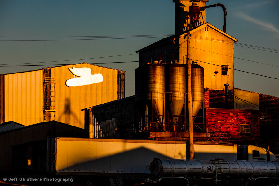 Metalic DeKalb Ag sign at sunset - Waterman, IL