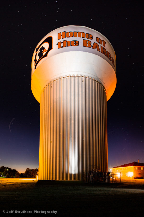 DeKalb Water Tower with Stars and Passing Airplanes