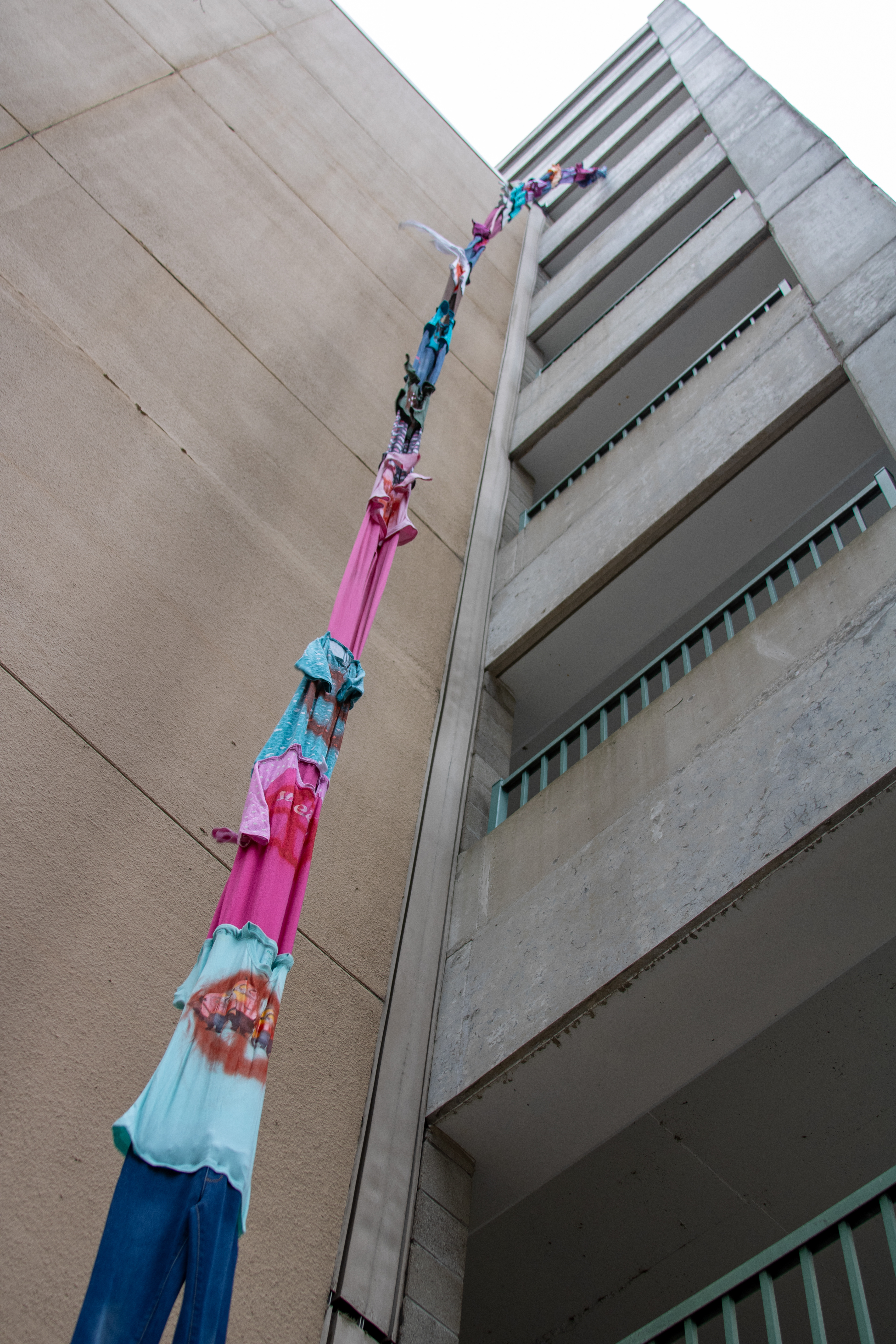 let down your hair | second-hand clothes, spray paint, thread, rope | 78’ x 1-2’ | 2025
