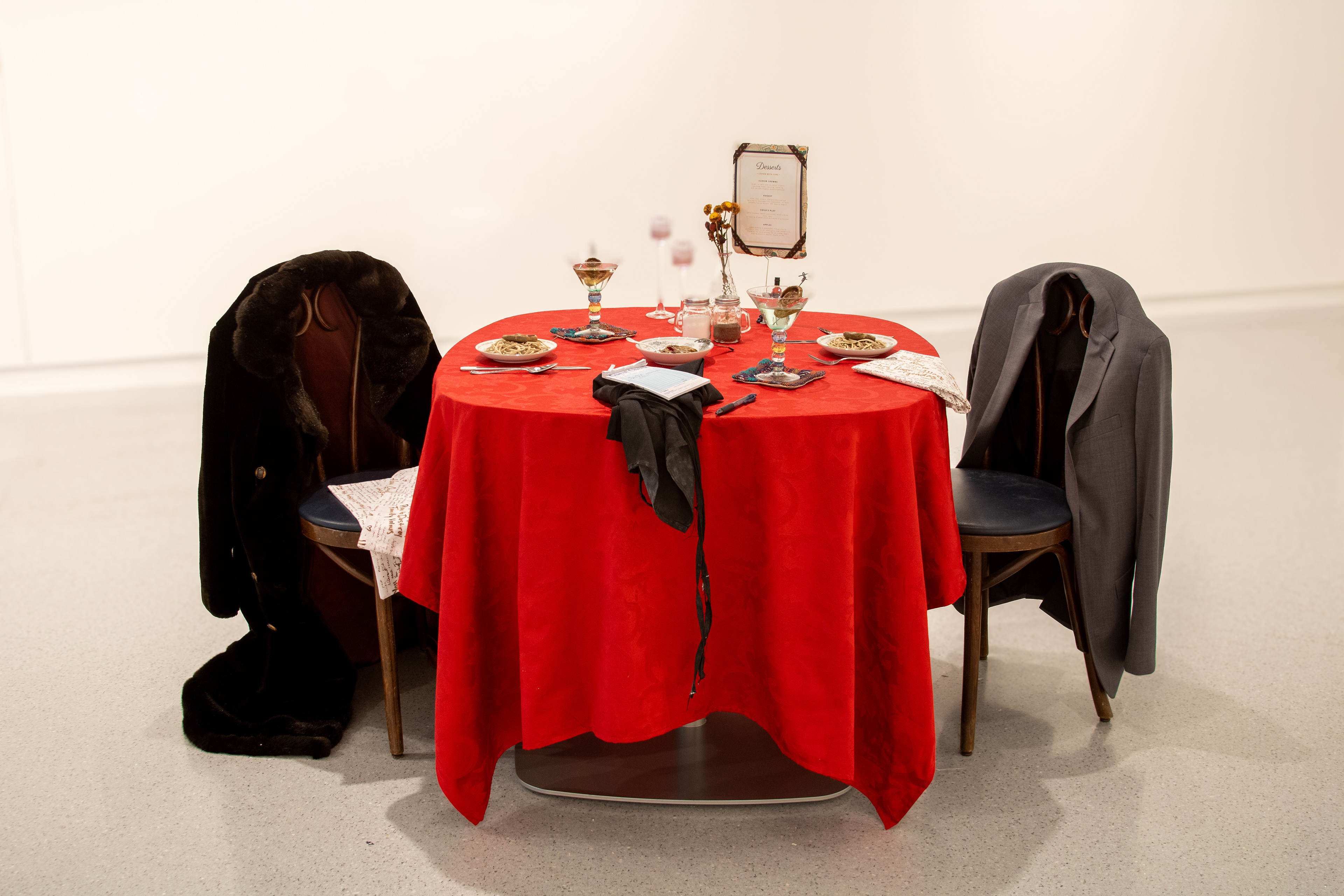 you are what you eat | found objects, woven fabric, screen printed and stitched cloth napkins with artist poetry, ceramic, artist-processed wild clay | 6’ x 3’ | 2025