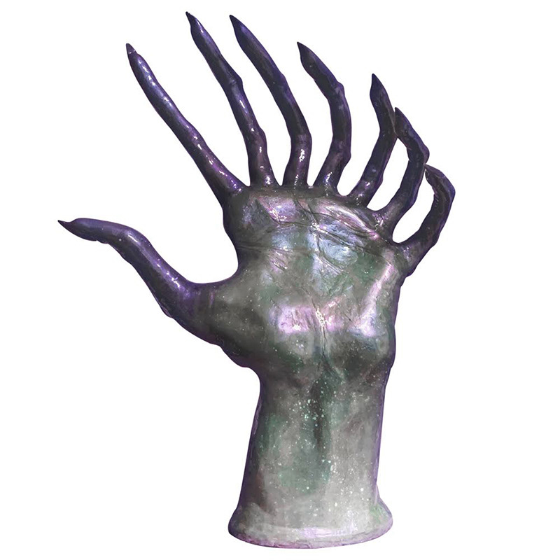 Sculpture of large purple and grey hand with many extra fingers.