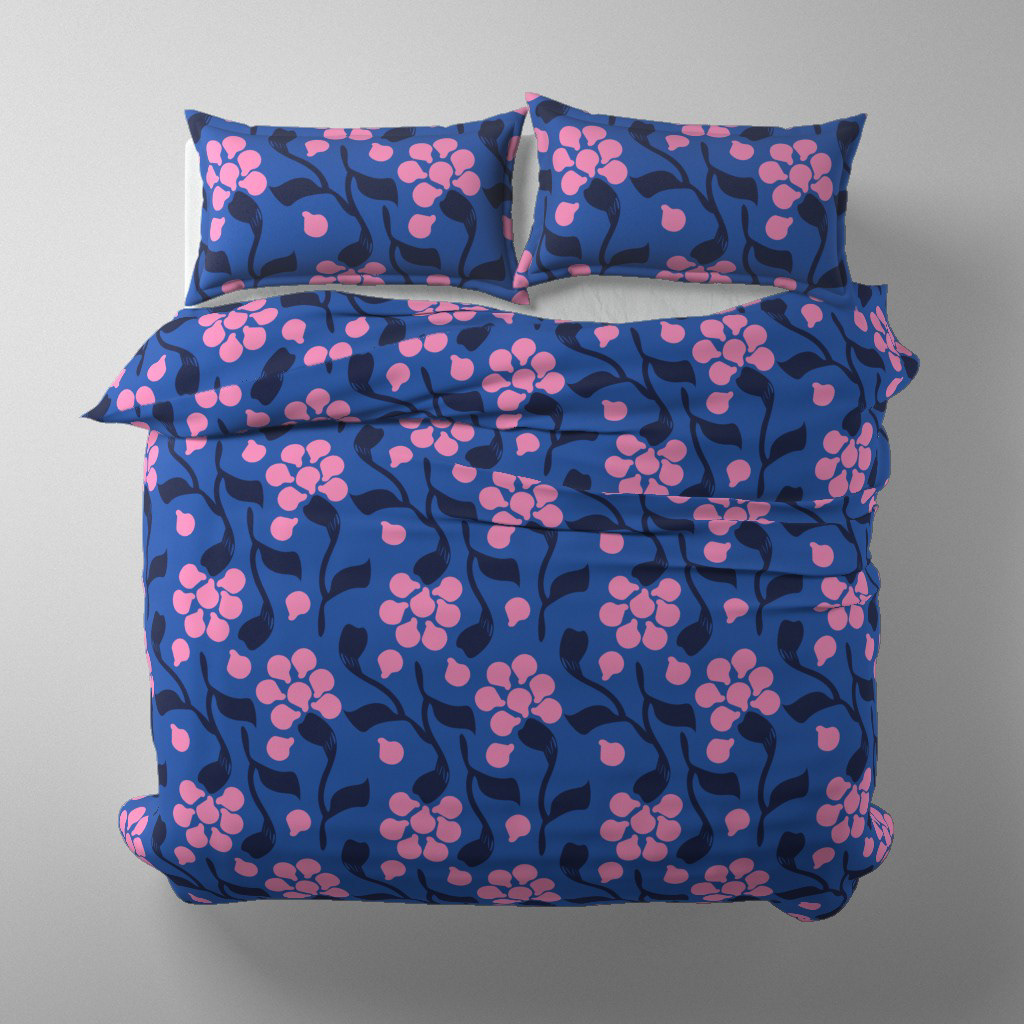 A bedroom display of a duvet cover in the "Summer Night in Helsinki Blue" pattern, a hand-painted floral design by Elli Maanpää.
