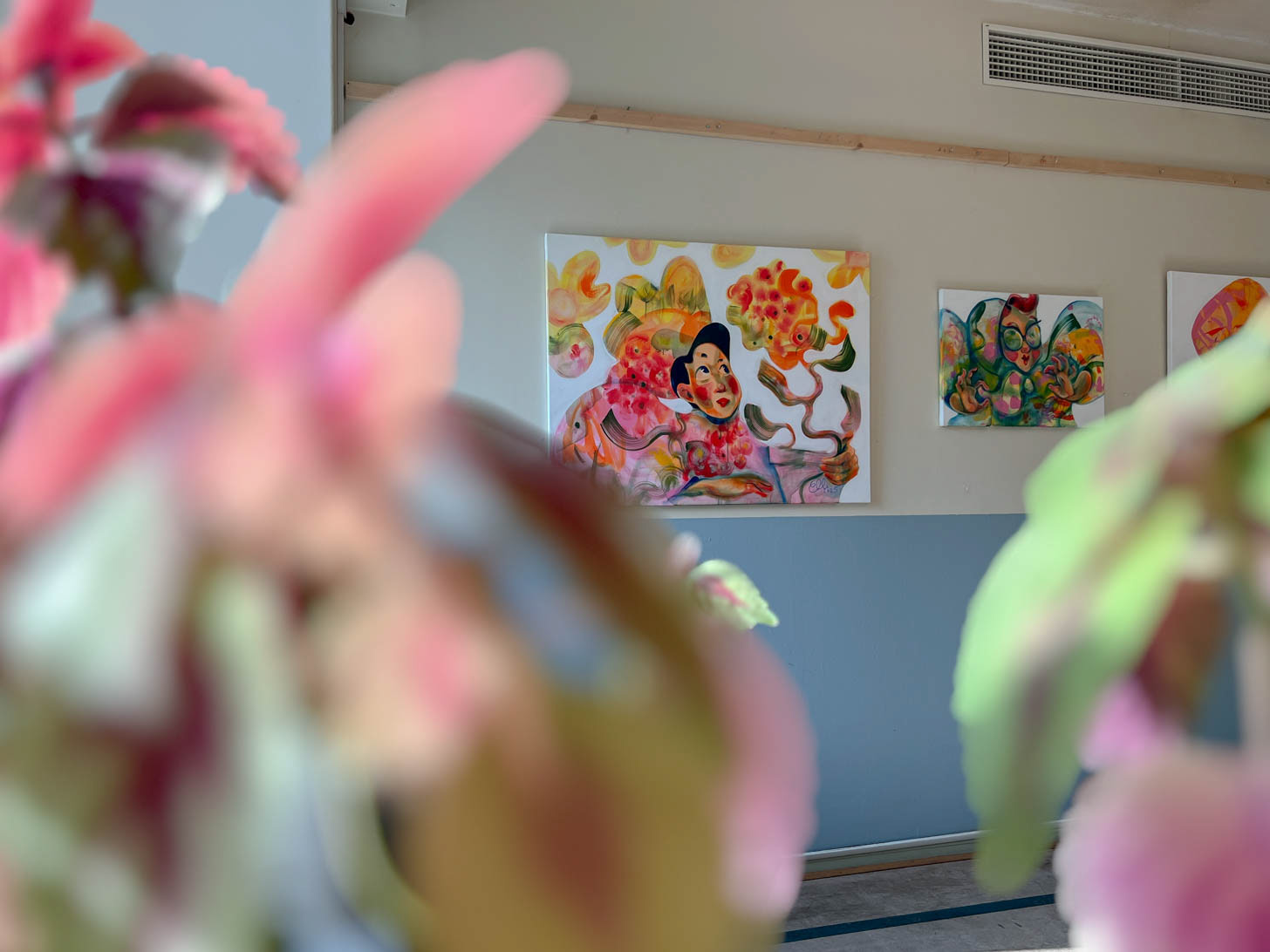 The acrylic painting "It was always you" by Elli Maanpää displayed alongside a gallery plant.