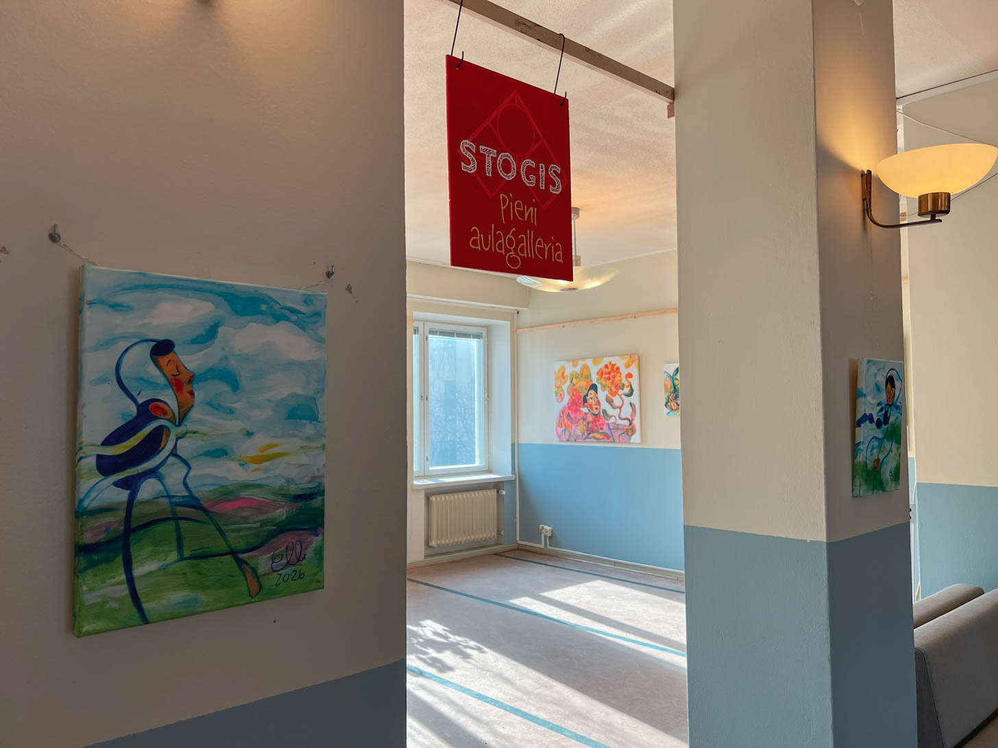The Stogis Aulagalleria entryway sign welcoming visitors to the exhibition, with Elli Maanpää's vibrant paintings on display inside the artist-run Meilahden Tilajakamo creative hub.