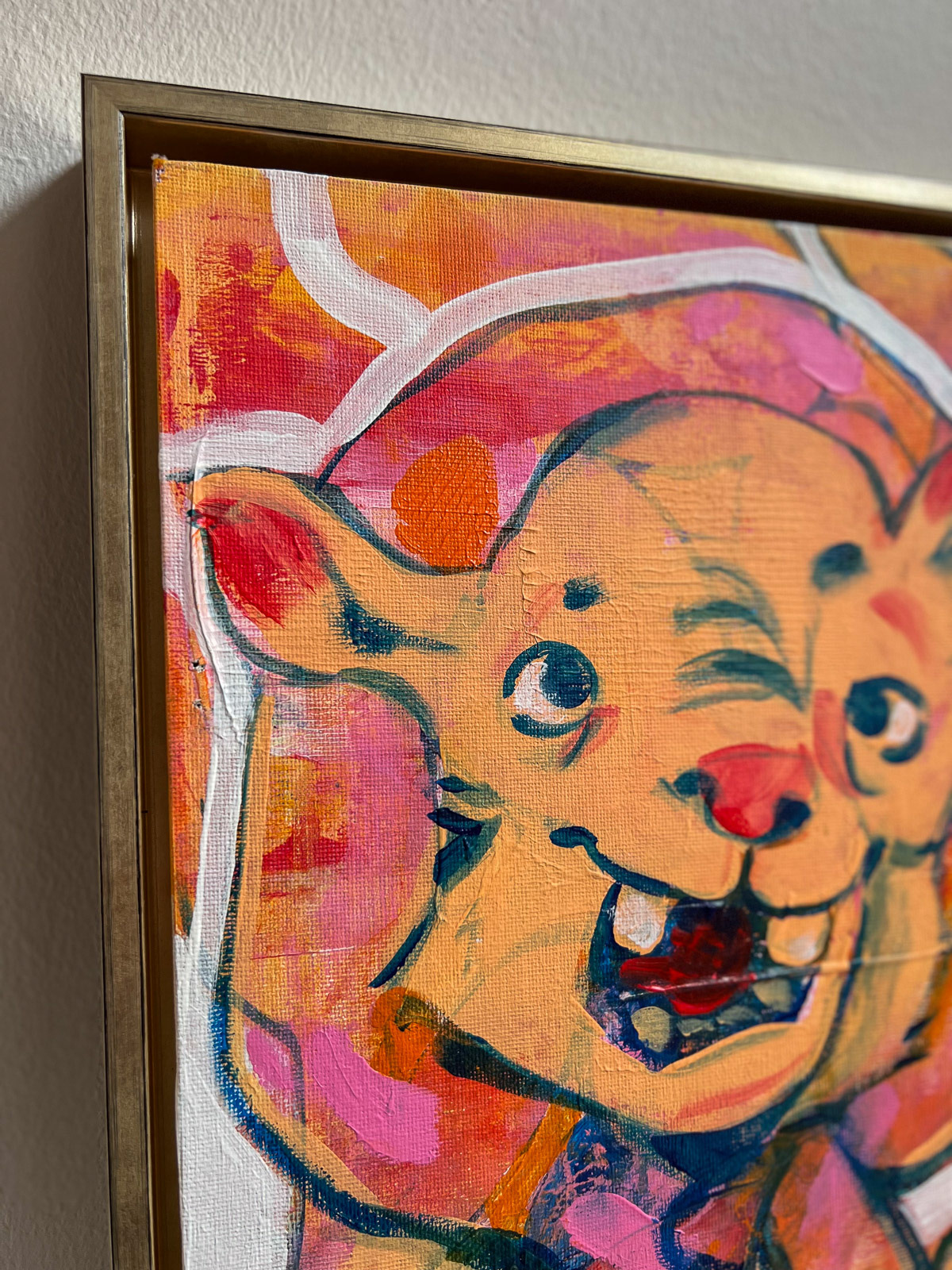 This colorful painting is framed with golden frame.