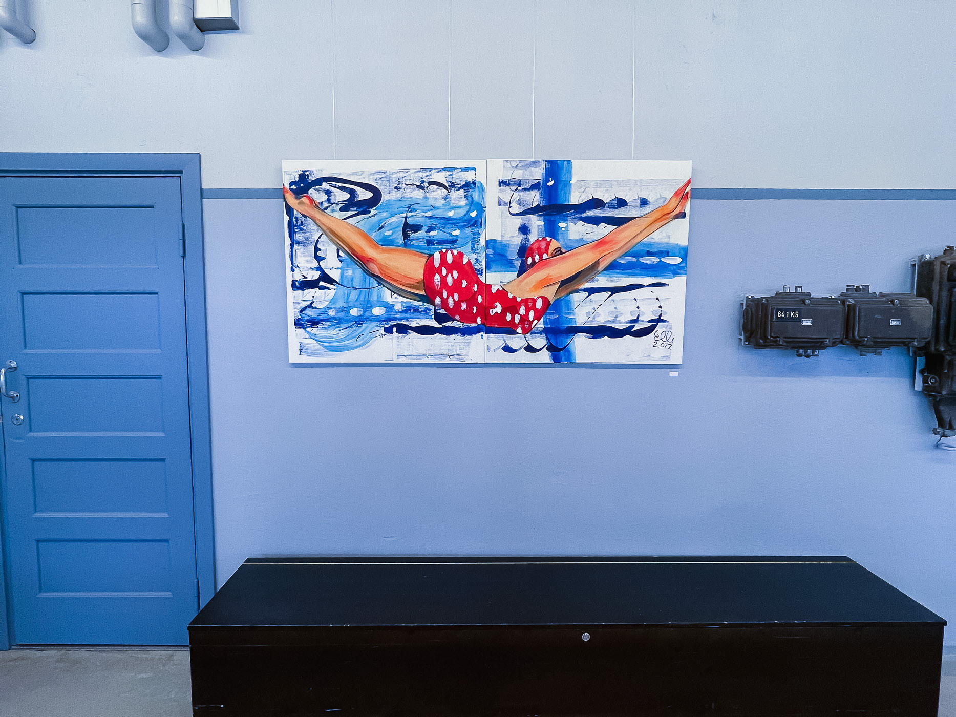  The centerpiece of the exhibition, Jump, captures a vintage-inspired moment of a woman in a red-and-white dotted swimsuit leaping into blue water