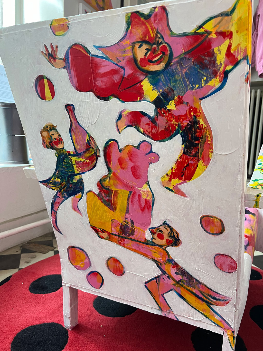 A close-up of the back of the chair reveals the details of the servants depicted in the artwork, adding narrative to the overall design of Throne.