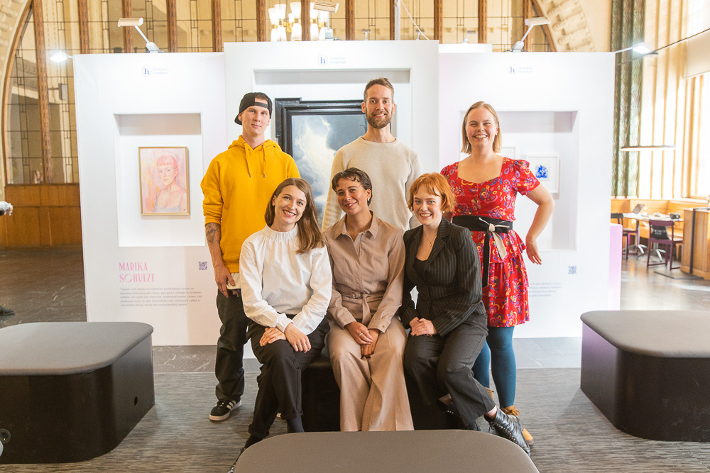 The six HELENE20 artists—Elli Maanpää, Emilio Mäkipää, Janne Jääskeläinen, Aura Latva-Somppi, Marika Schulze, and Alma Peltola—posing in the exhibition space in Helsinki.