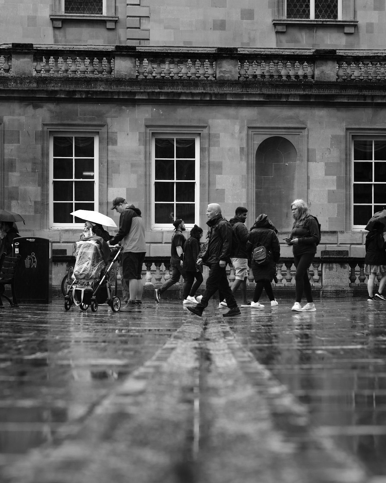 Group of people walking over drain