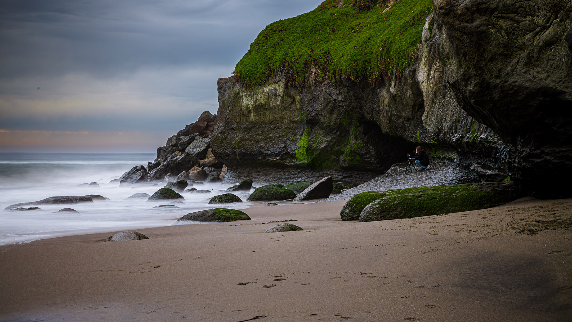 A 15 second long exposure of my wife photographing the waves on the beach in Santa Cruz