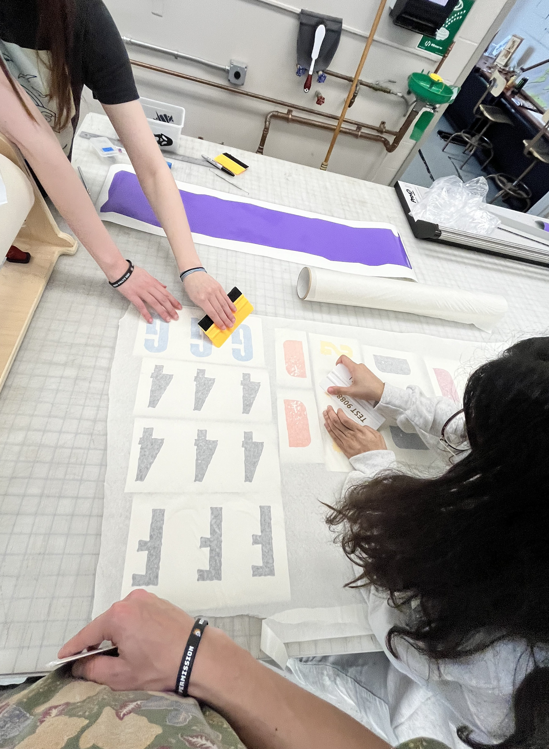 Aeneas, Sheyla, and I preparing the smaller vinyl lettering in the printing lab.
