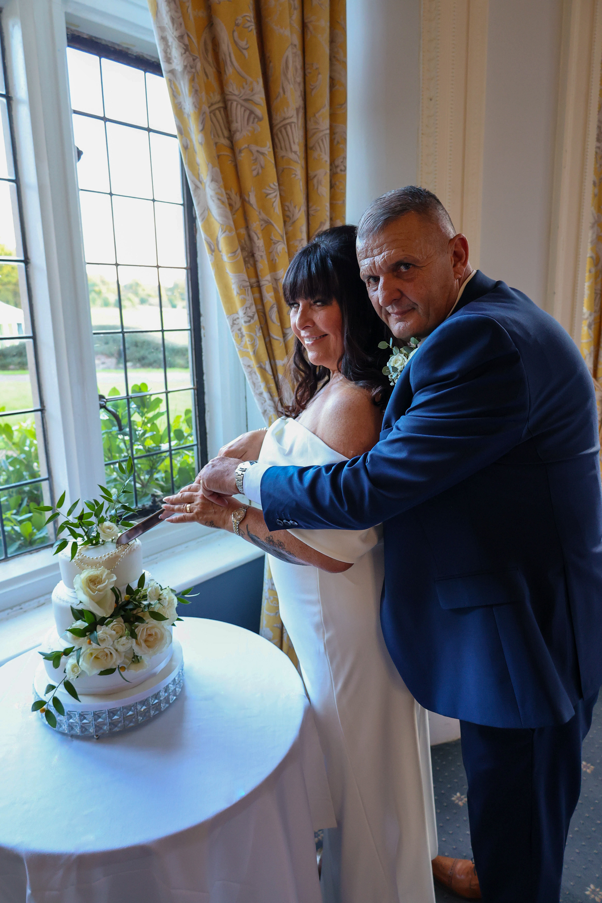 Romantic cake cutting at a stunning Kent wedding venue.