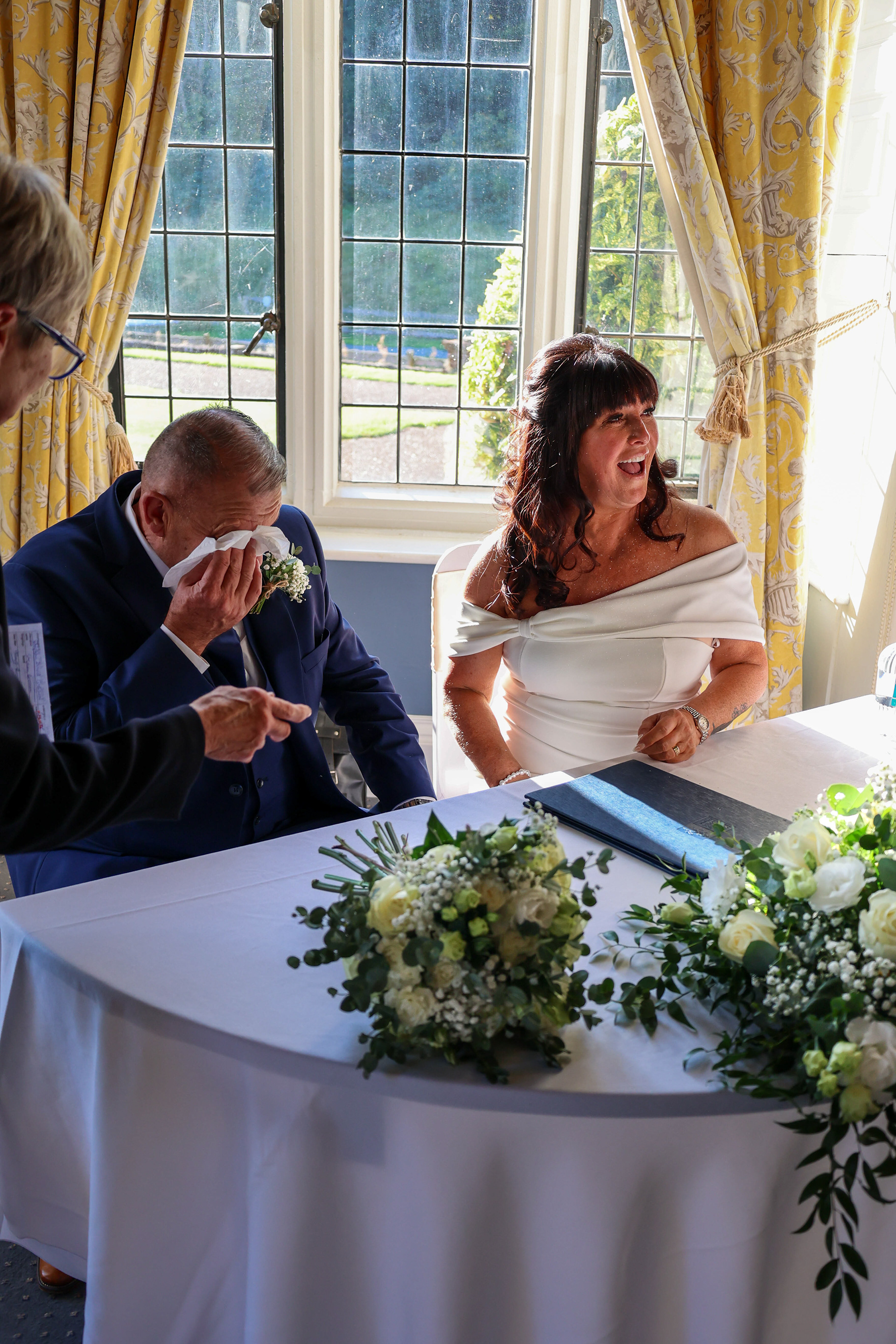 An unforgettable moment: The groom sheds tears of joy while signing the wedding certificate.