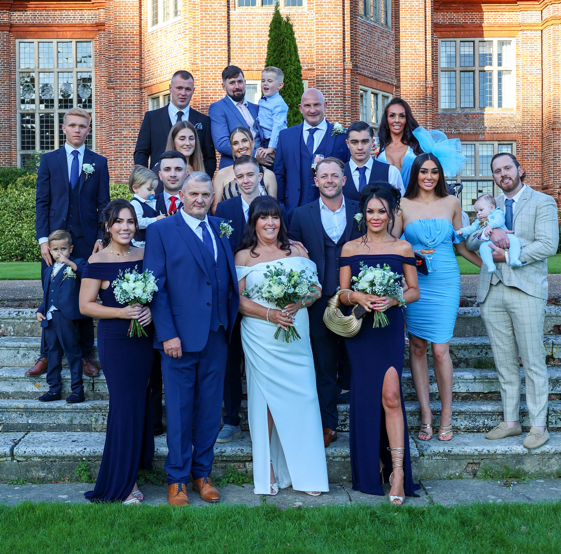 Wedding party's grand celebration in front of Broome Park's elegant Georgian mansion in Canterbury.