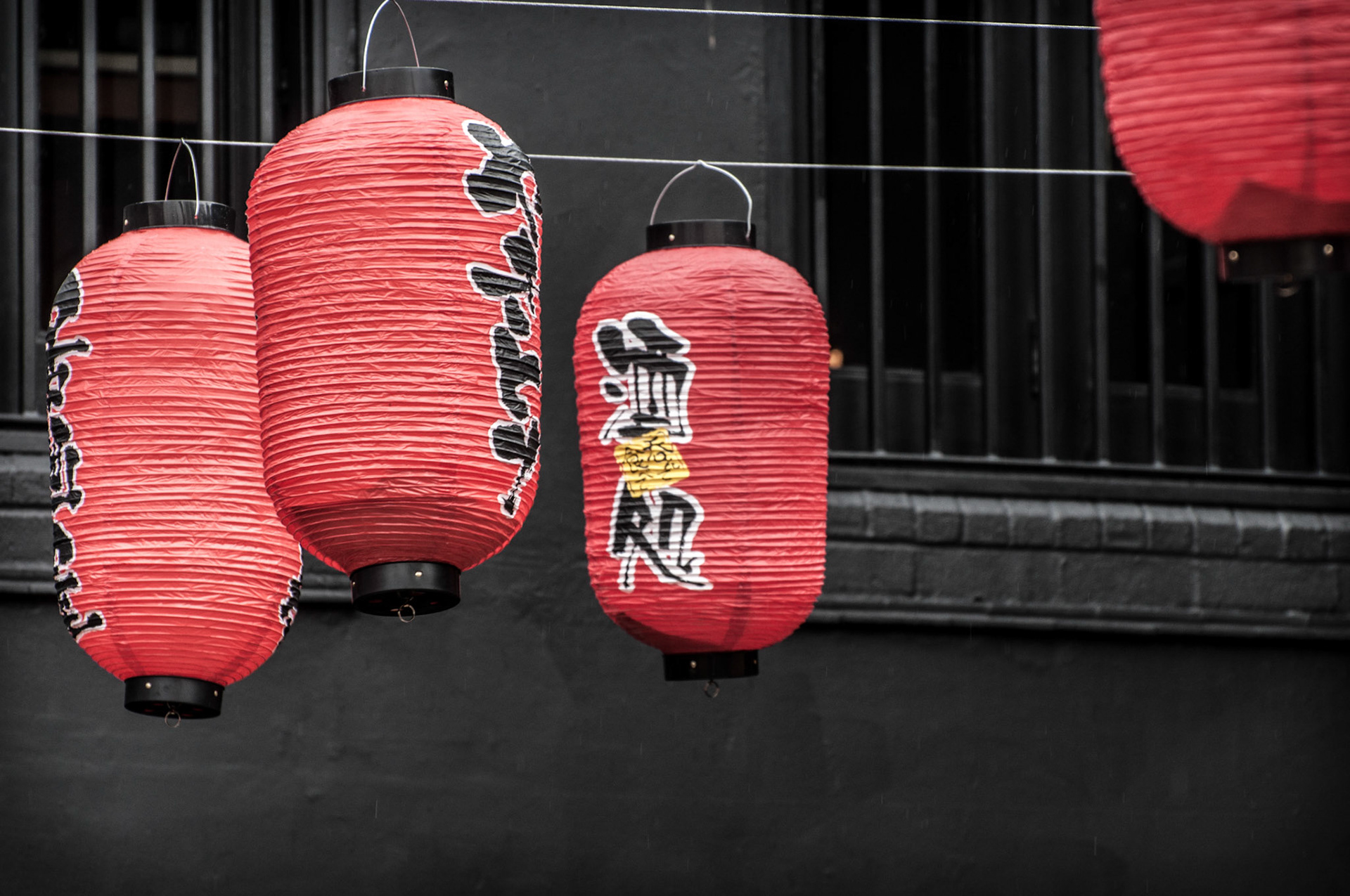 On a wet and windy day, these lanterns are swinging about in the courtyard.