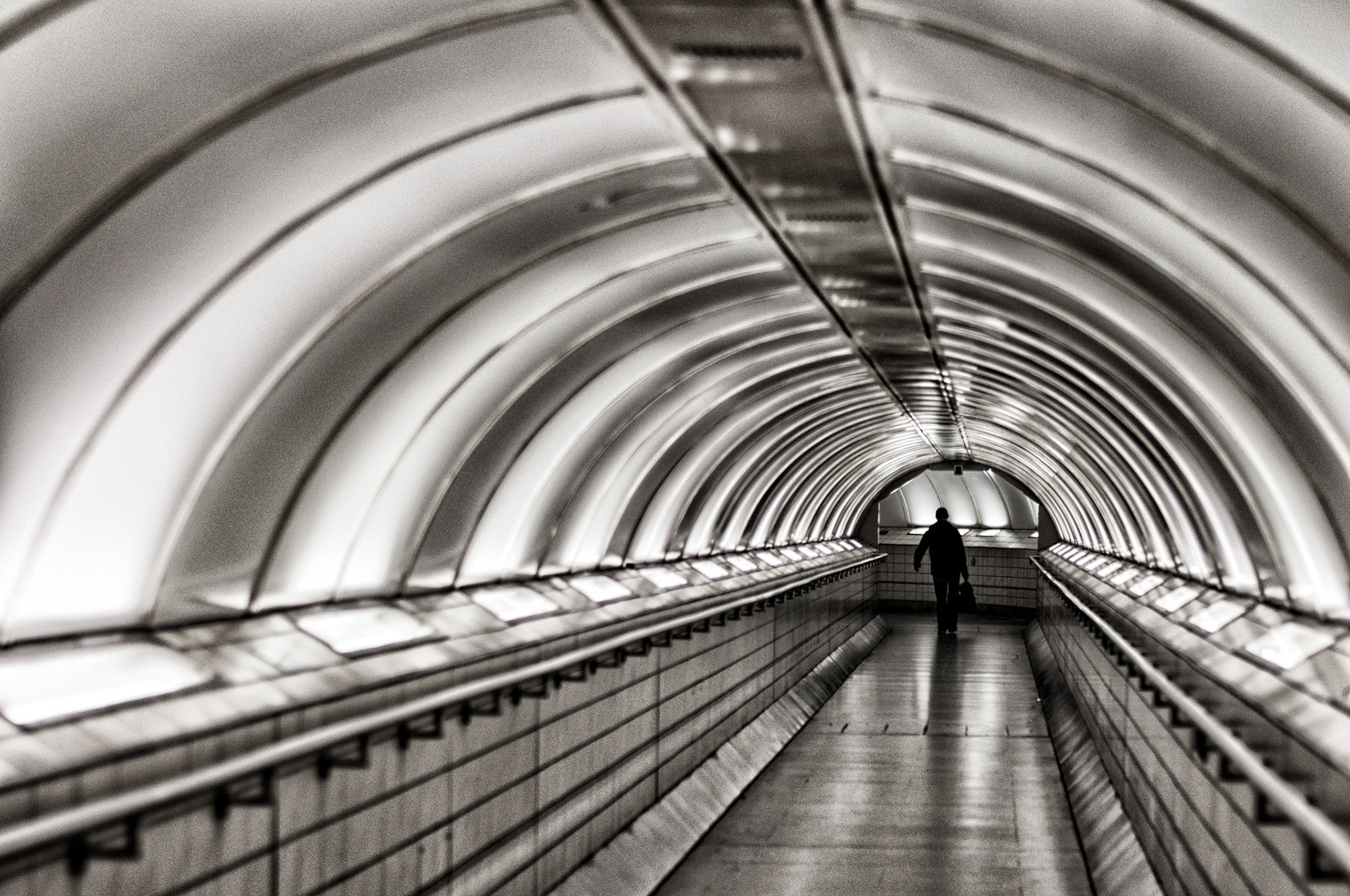At one of the busiest interchanges, on one of the busiest underground systems in the world. The traveler in this desolate tunnel was seen at rush hour getting to work.