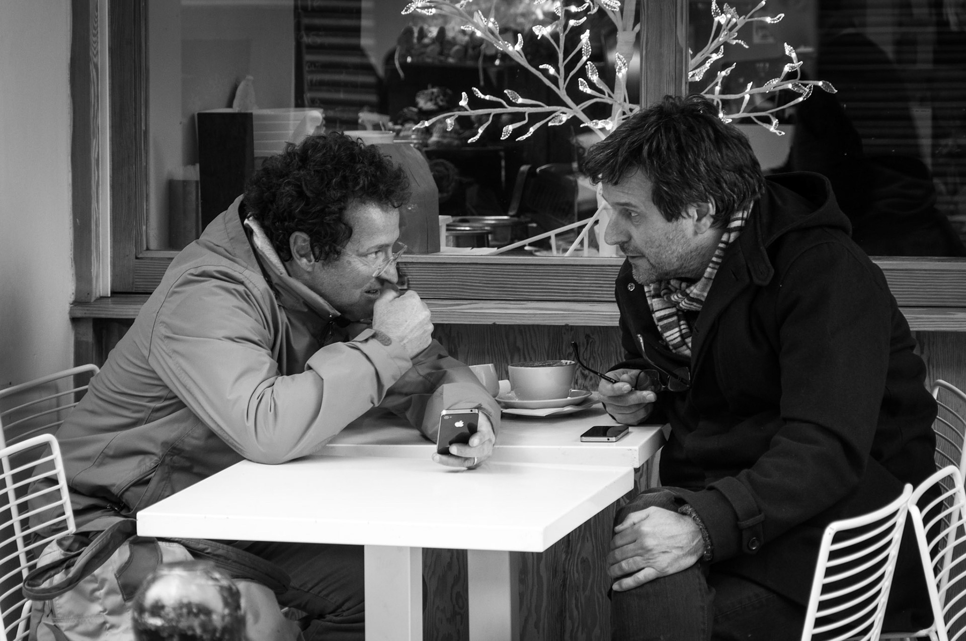 This pair were at a cafe discussing items "in the virtual world" on their mobile.