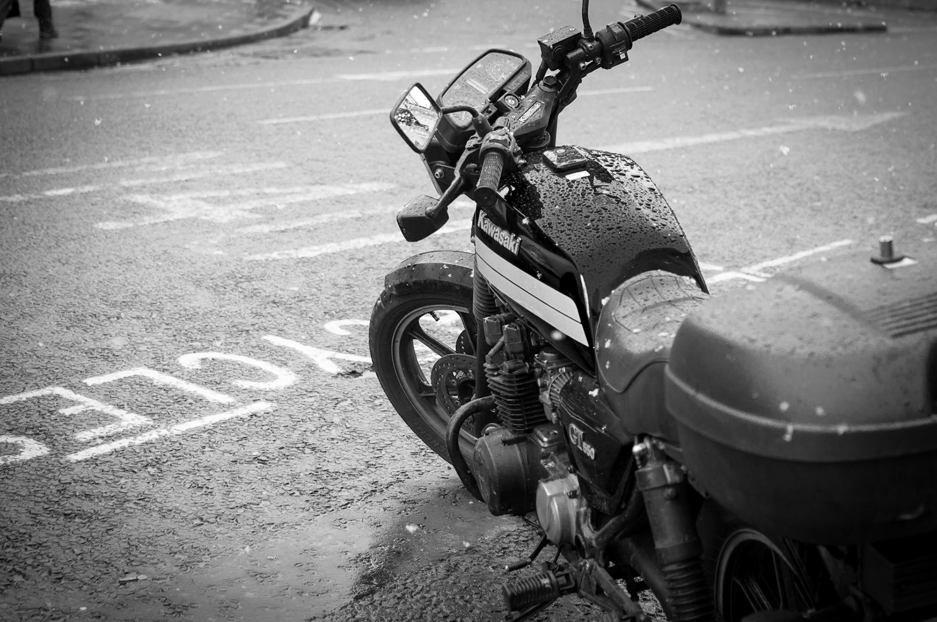Parked outside of work, this bike sits idly in the falling snow.