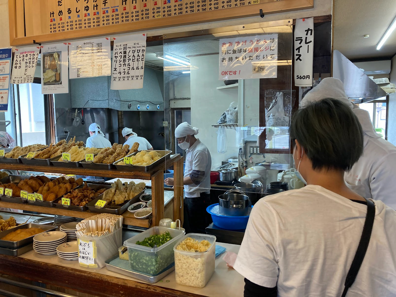 eyeing the various tempura toppings to choose